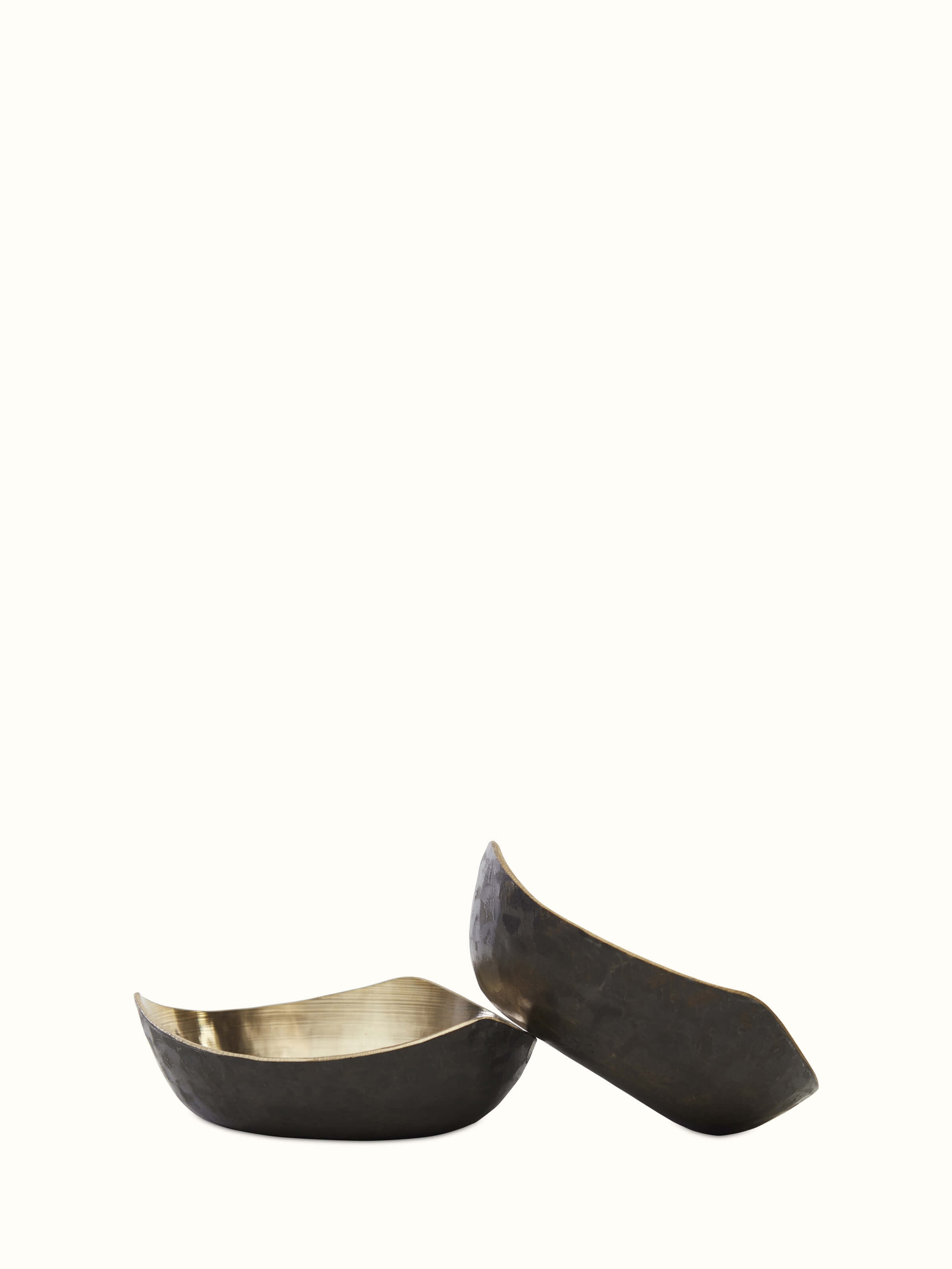 Angled view of Bell metal triangular dinner bowl emphasizing its distinctive shape and smooth brass finish