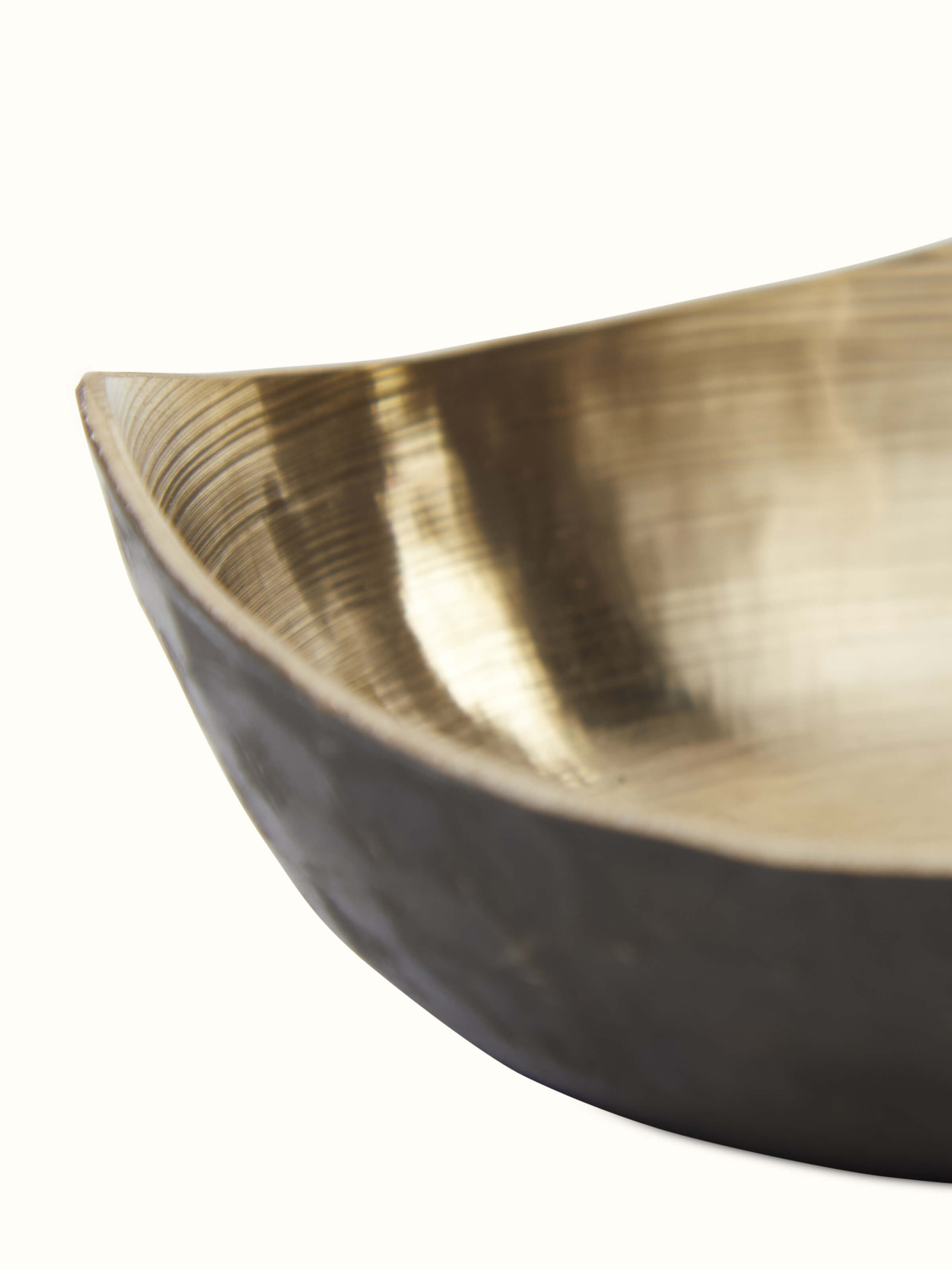 Close-up view of Bell metal triangular dinner bowl focusing on the intricate texture and high-quality metalwork