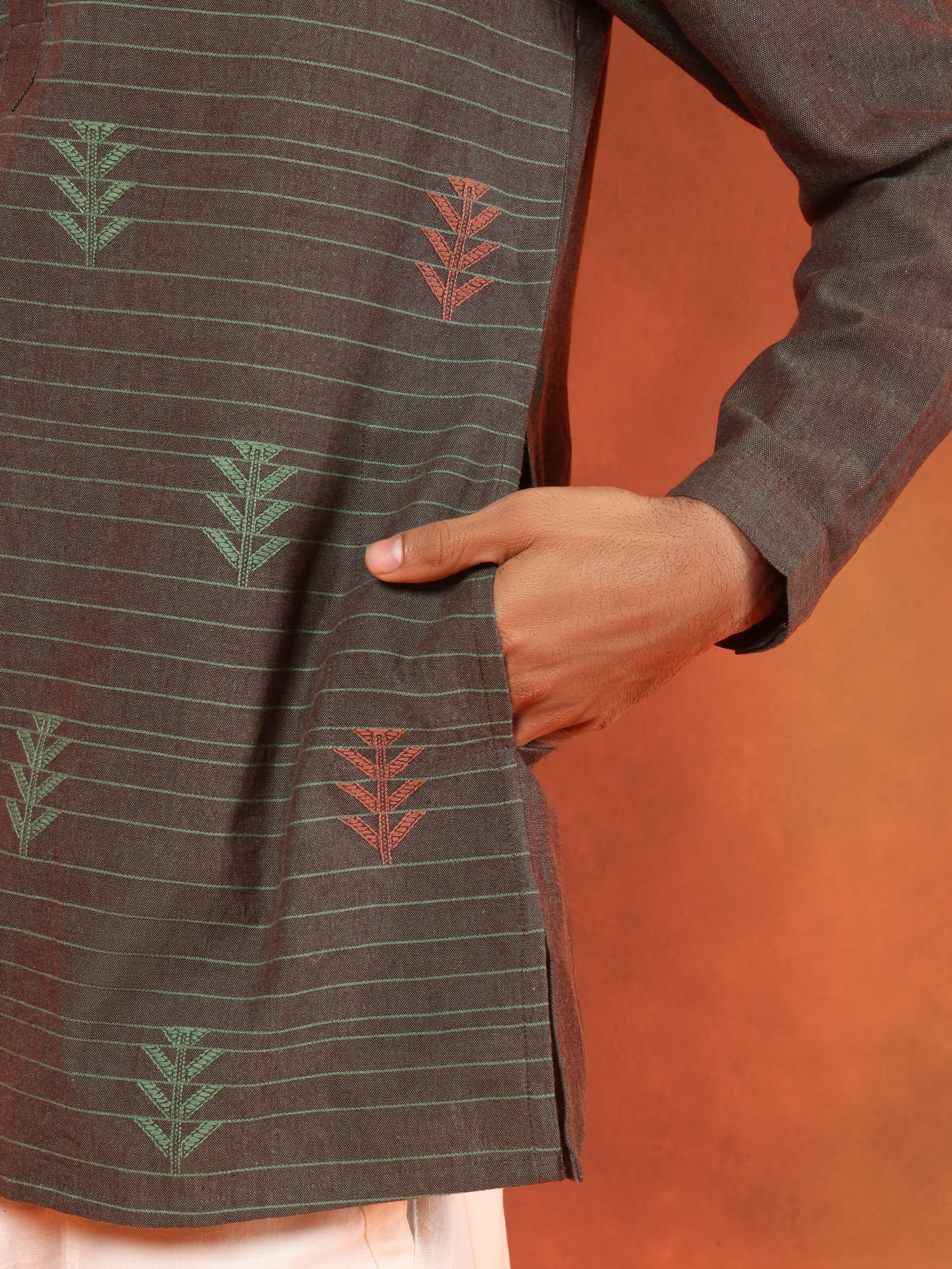 Detail shot of brown cotton short kurta showing weave patterns and front placket.