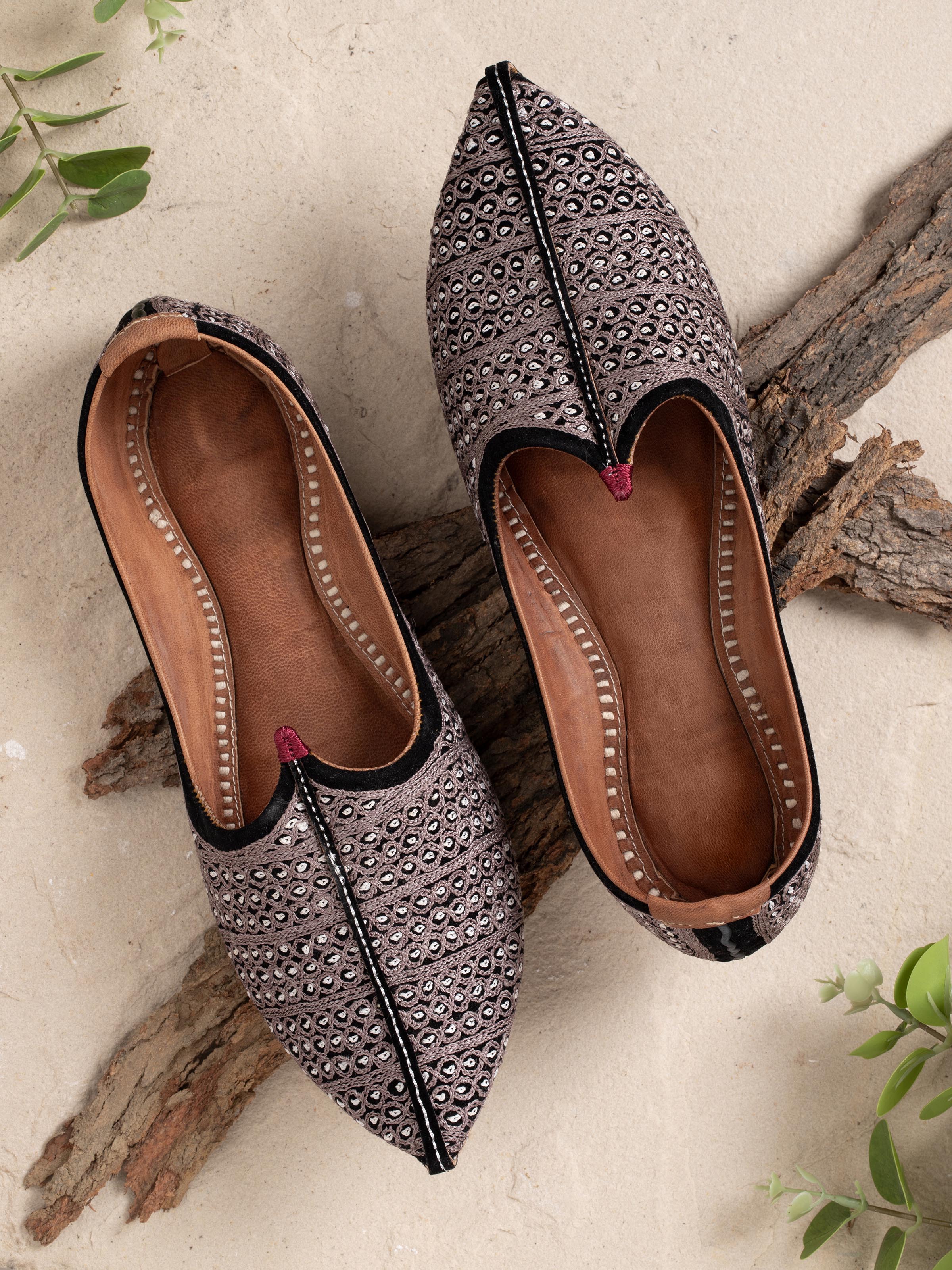 Side view of tan leather embroidered Jodhpuri pagrakha with focus on detailed patterns