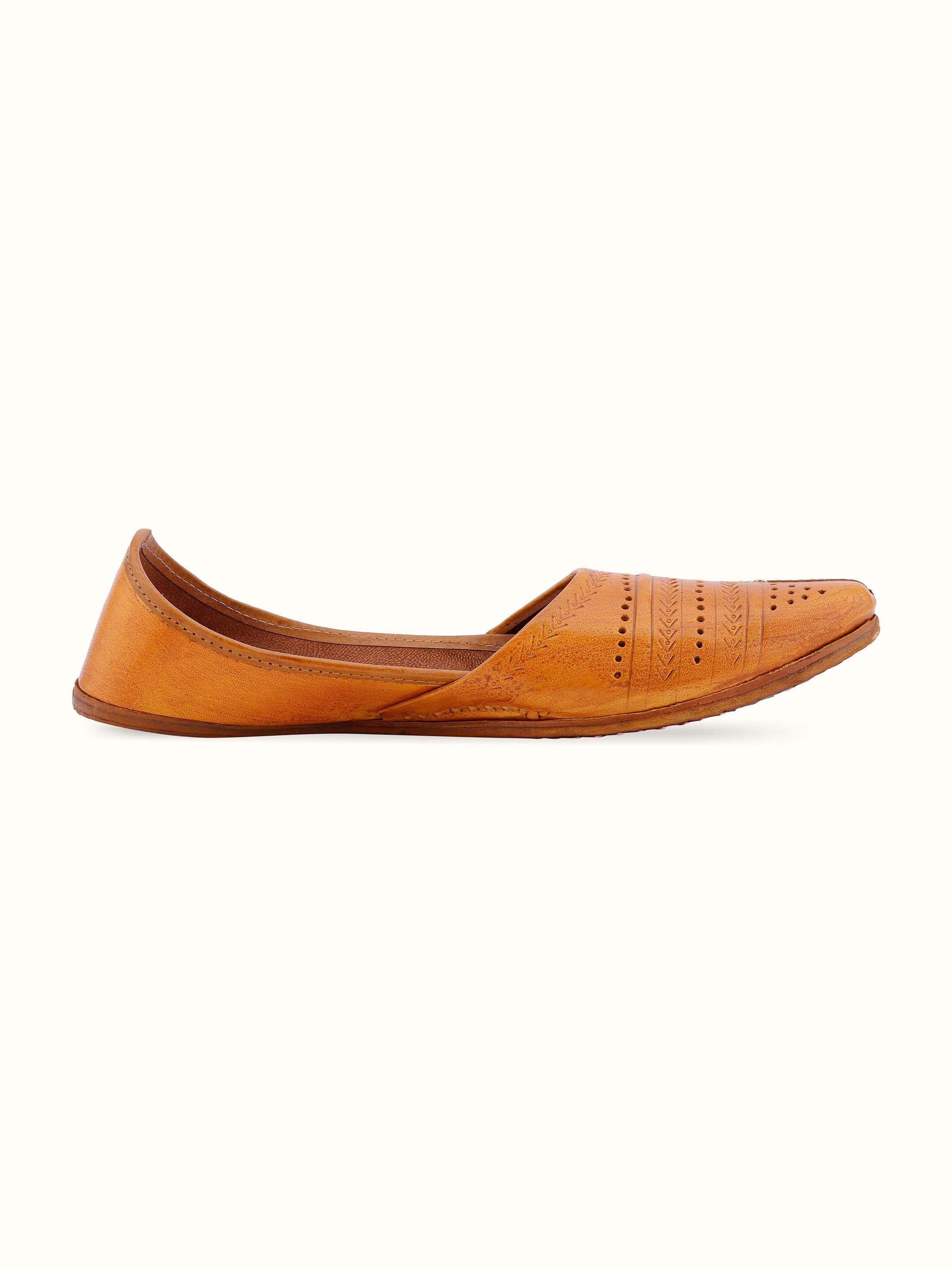 Angled view of Tan Leather Haryana Punjabi Juttis highlighting the design and structure.
