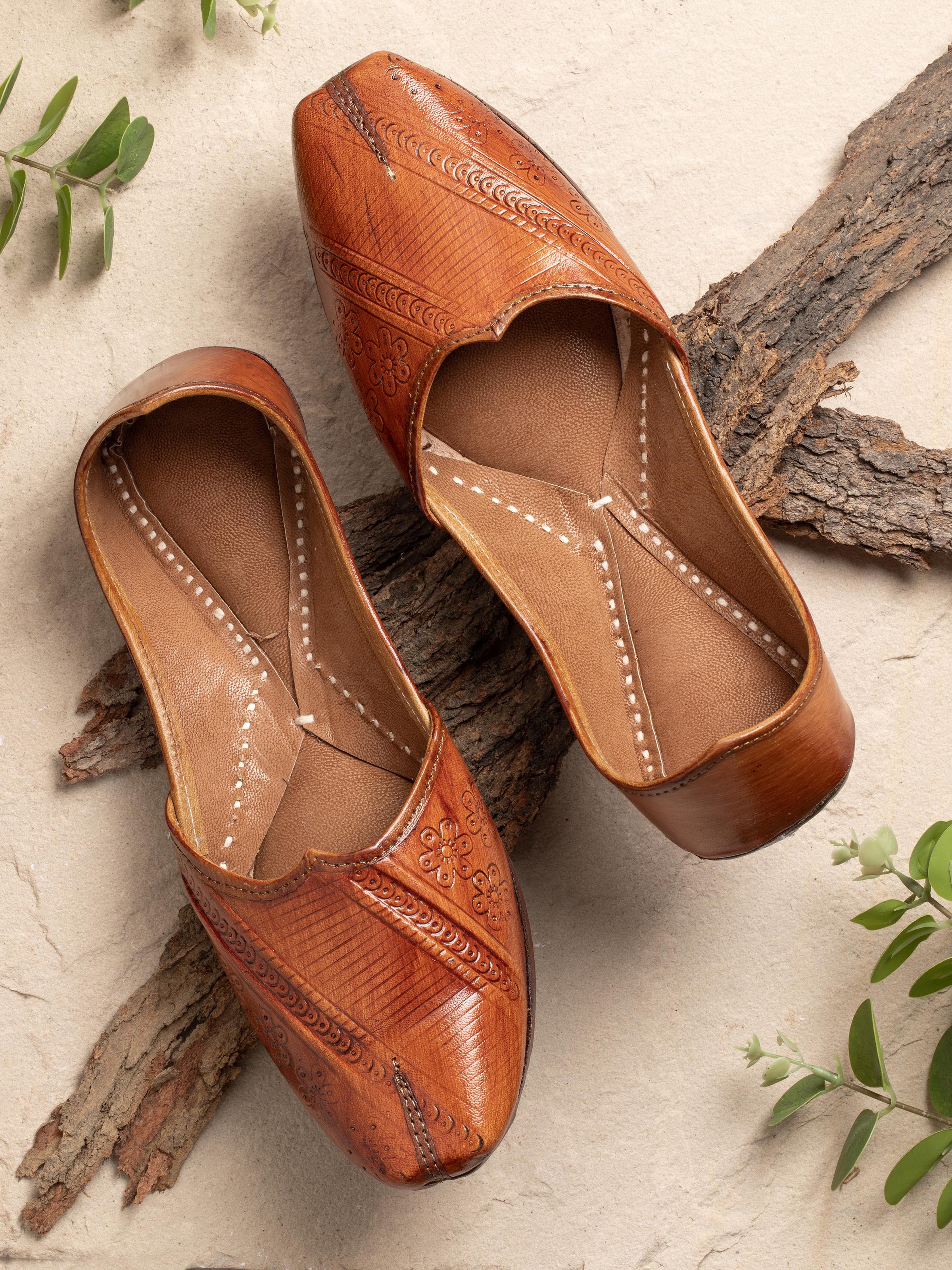 Side view of Tan Leather Haryana Punjabi Juttis focusing on the stitching and shape.