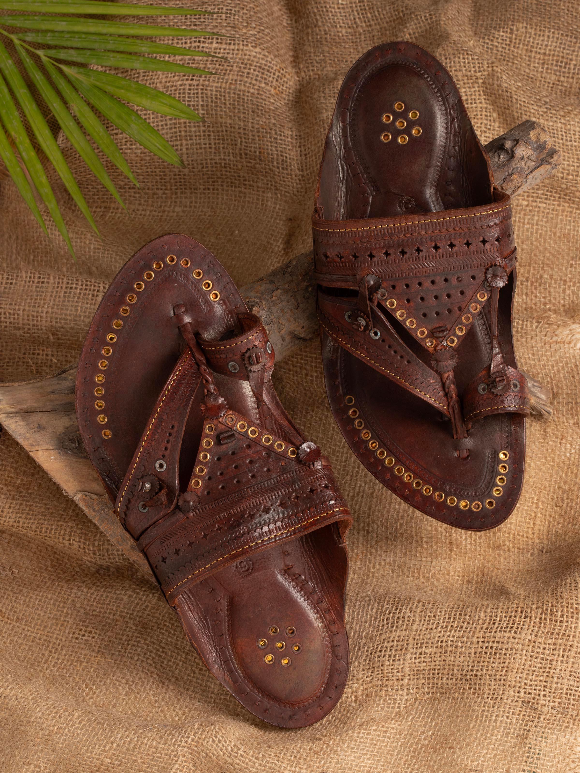 Side view of tan leather Kolhapuri chappals highlighting the detailed leatherwork
