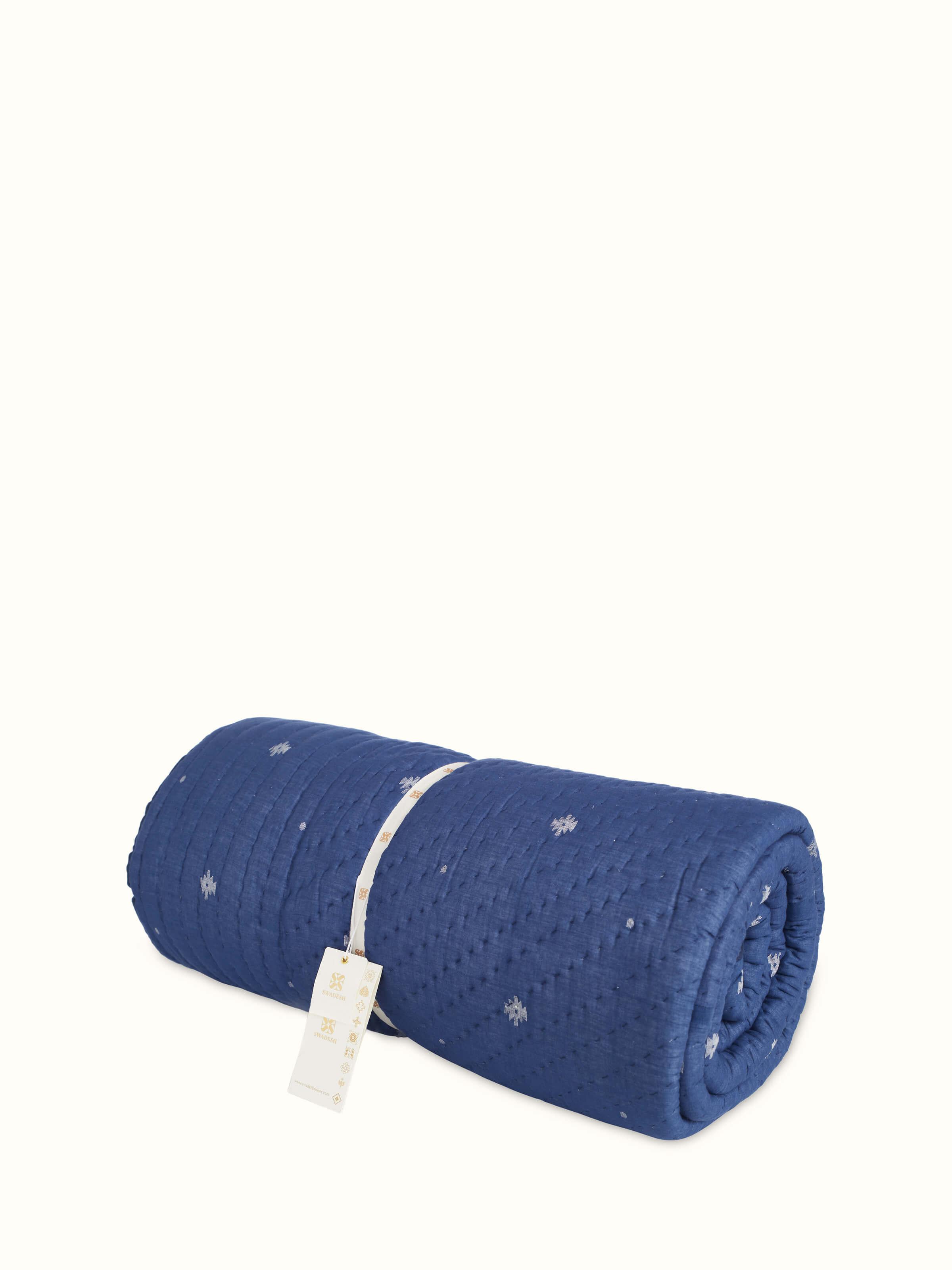 Detailed view of Kalpanama indigo woven buti cotton quilt double focusing on the buti patterns and fabric texture