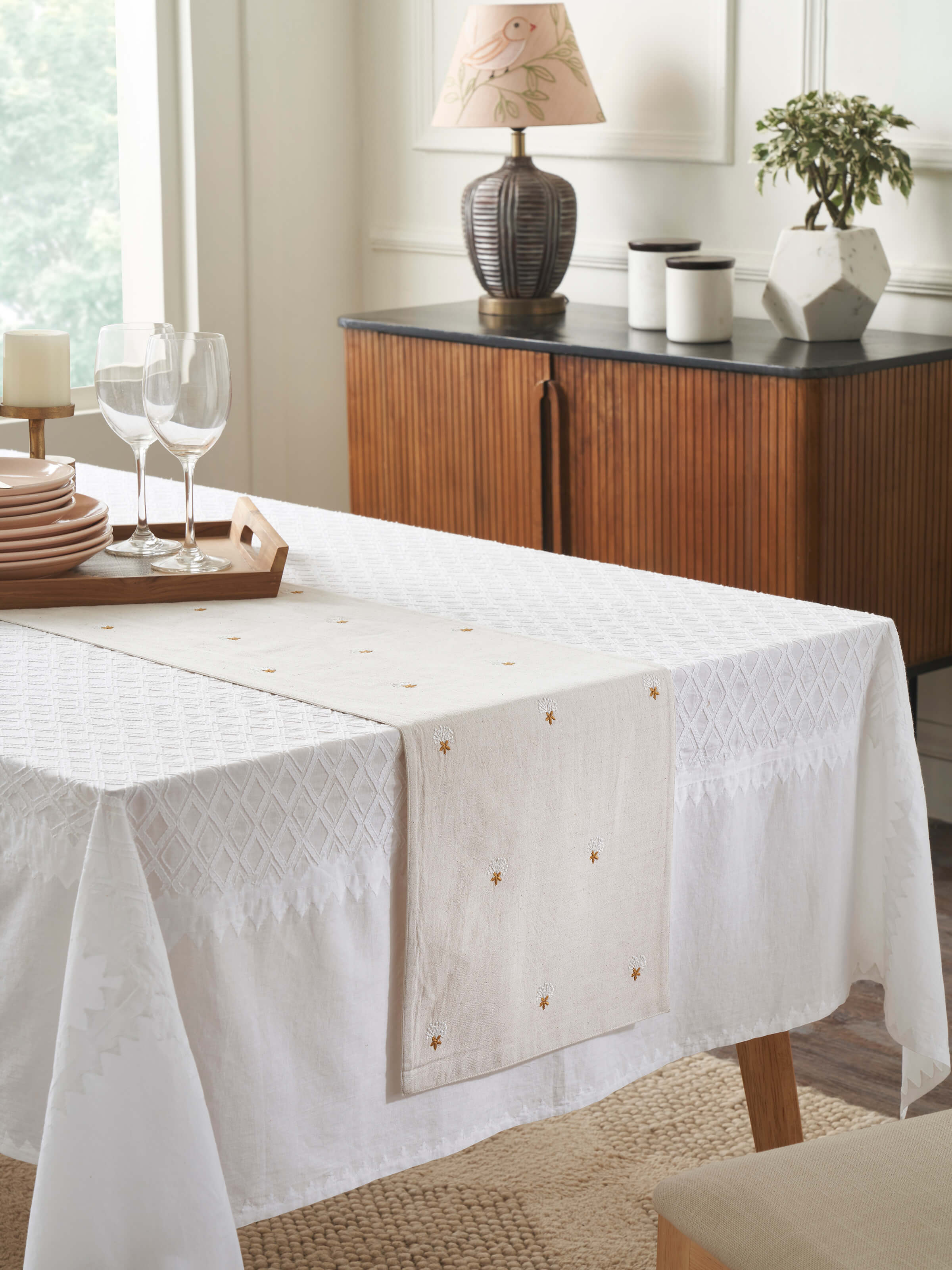 Lifestyle view of Iti Buti Beige Table Runner styled on a traditional wooden dining table