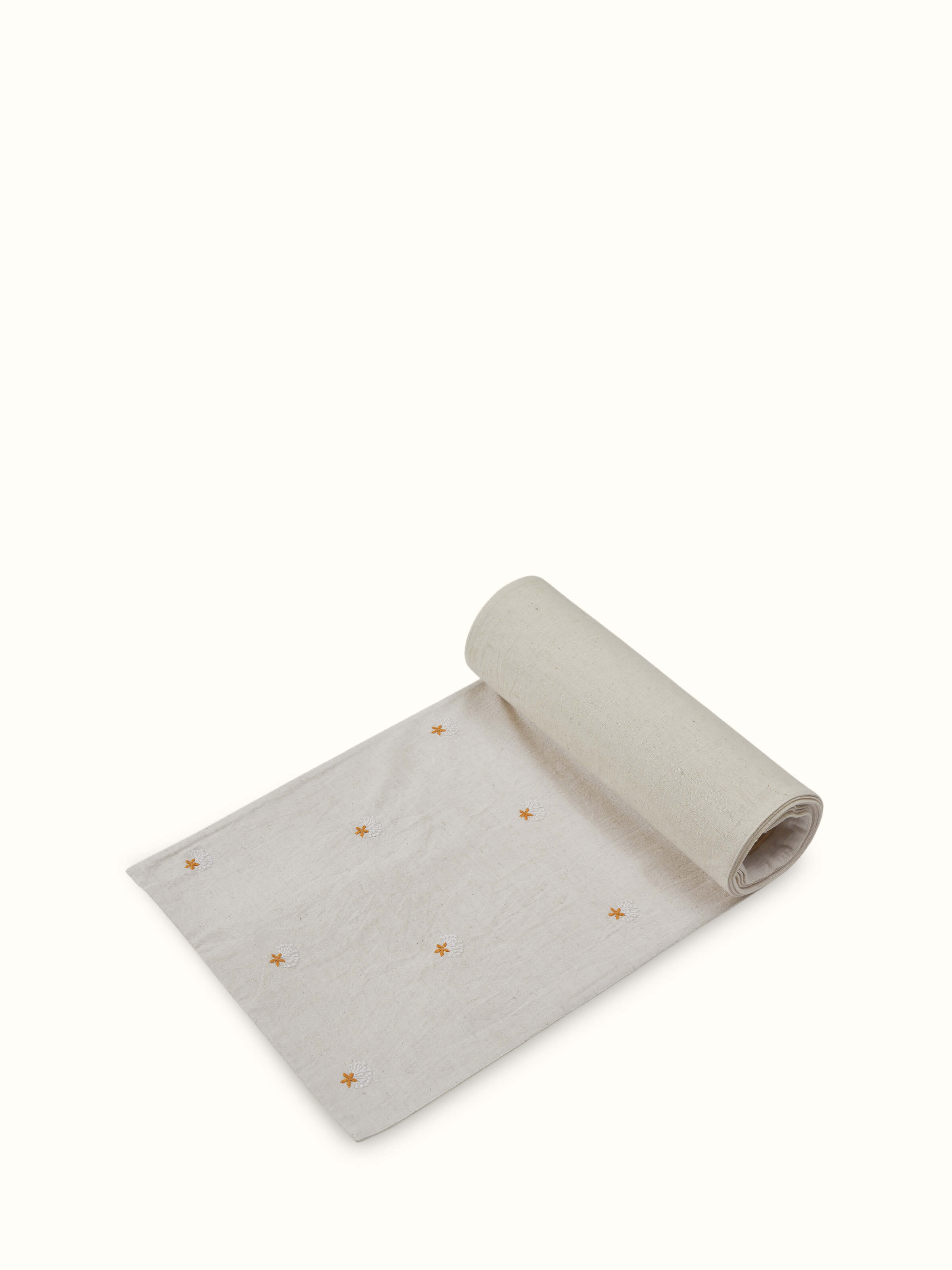 Angled view of Iti Buti Chikankari Table Runner revealing floral hand embroidery pattern