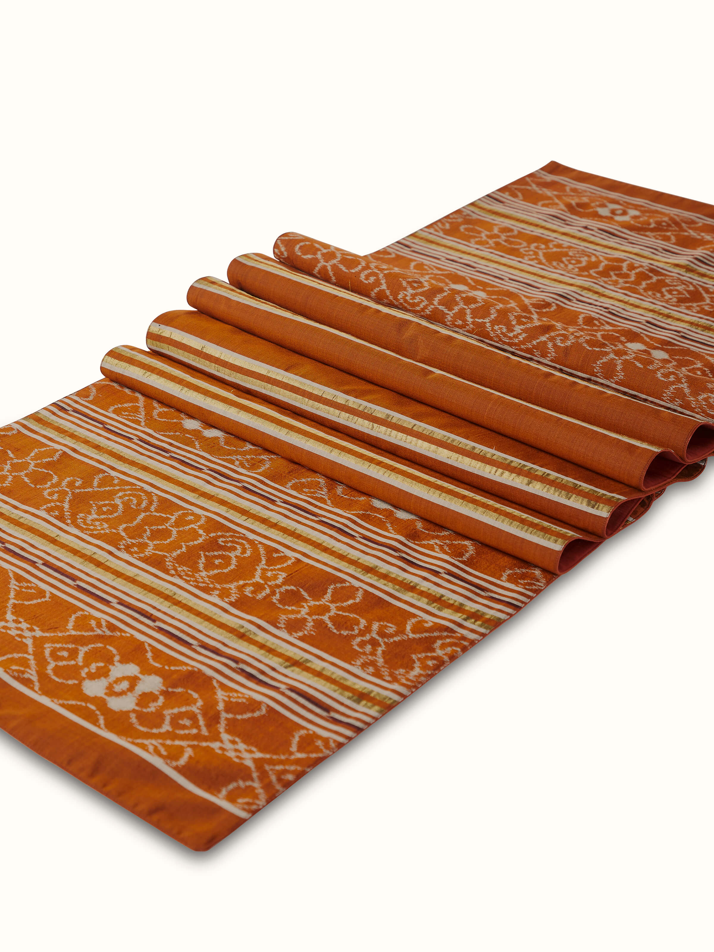 Detailed Ikat weave in rich rust and neutral tones, highlighting handloom craftsmanship.