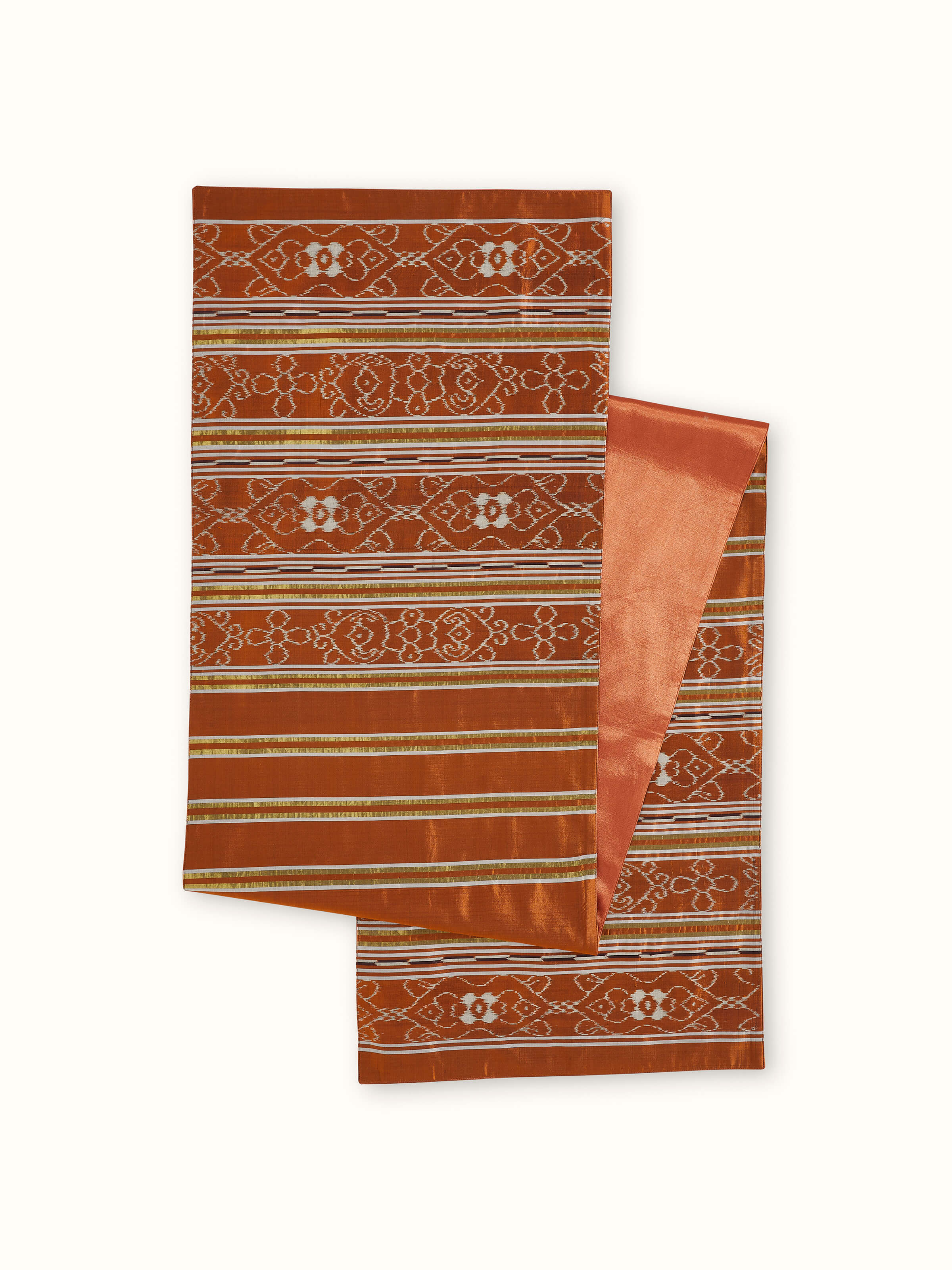 Angled back view of rust-striped silk bed runner with handloom texture and color gradient.