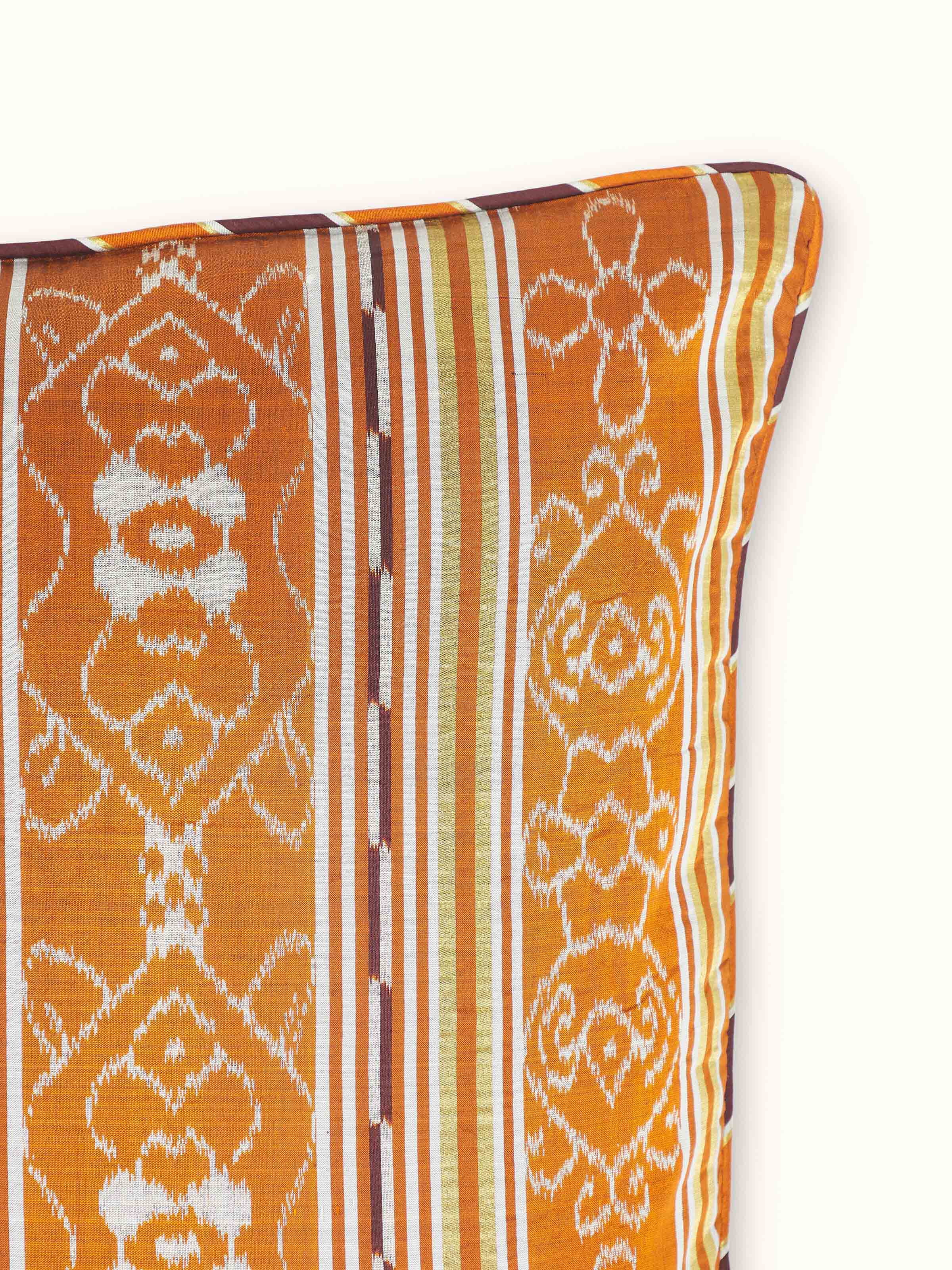 Detailed close-up of Sanchaya rust allover stripe silk Odisha ikat handloom cushion cover, focusing on the ikat weaving.