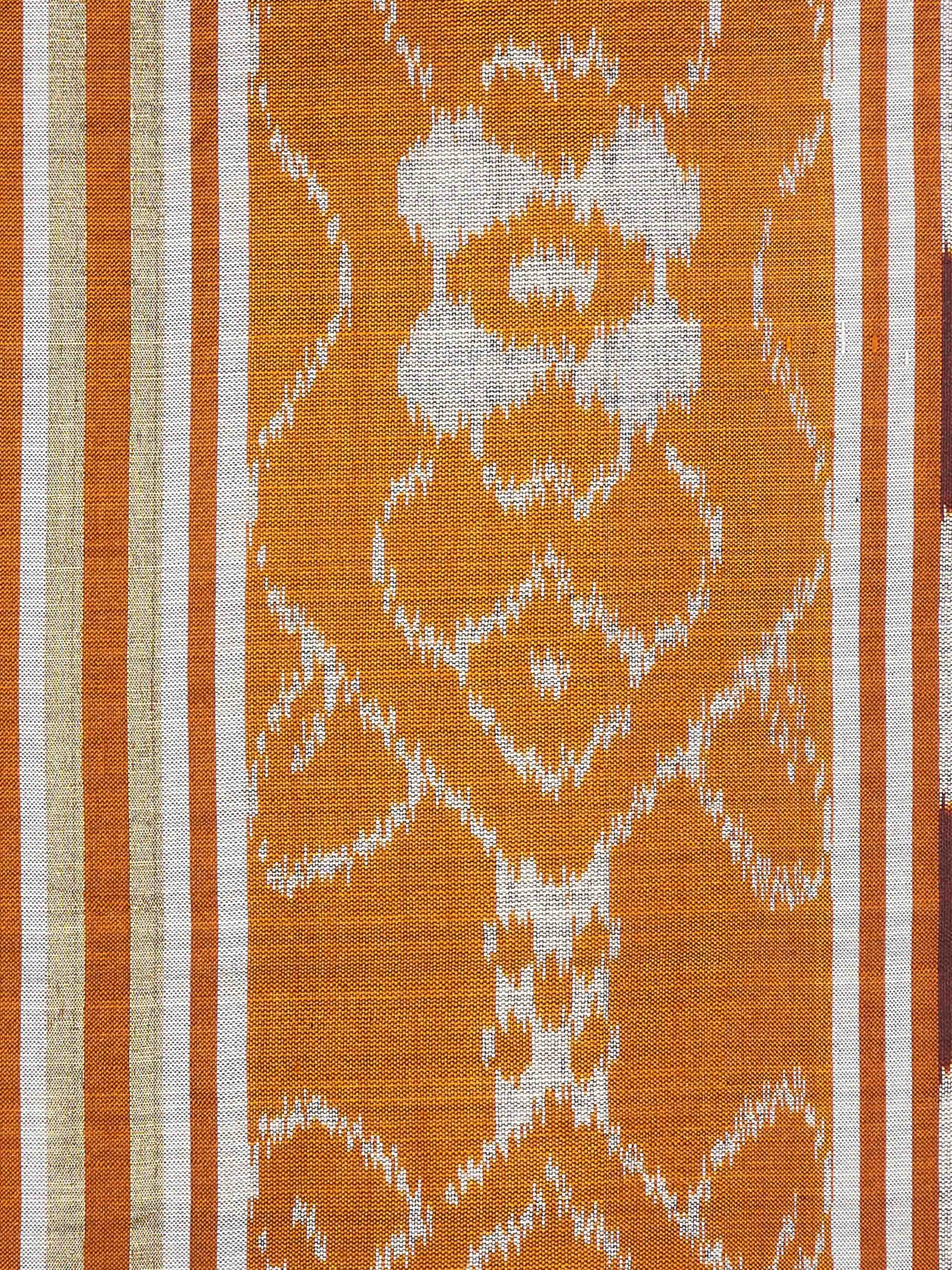 Close-up view of Sanchaya rust allover stripe silk Odisha ikat handloom cushion cover, emphasizing the detailed stripes and fabric.