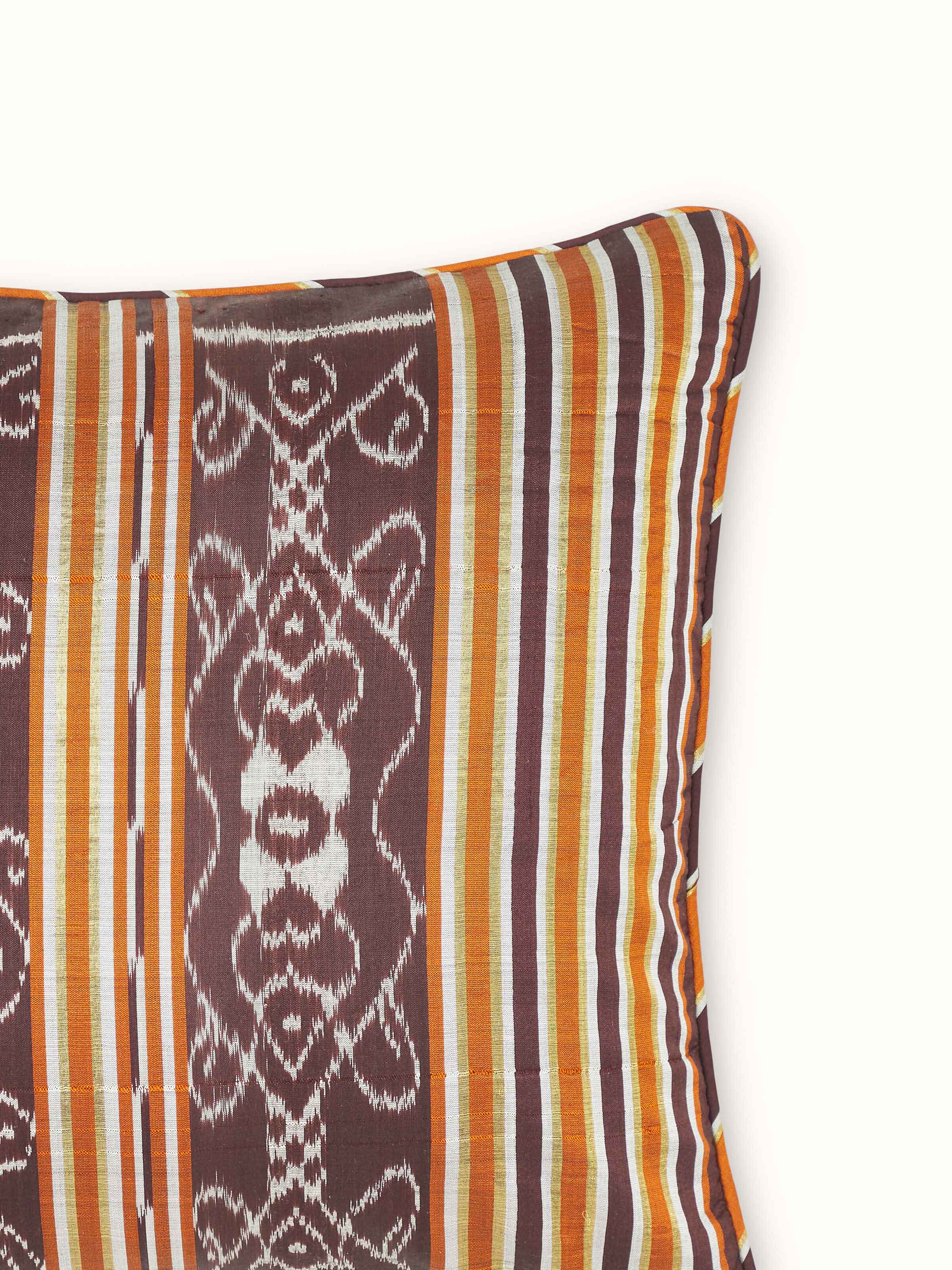 Detailed close-up of Sanchaya coffee stripe silk lumbar cushion cover, showcasing the intricate Odisha handloom Ikat weaving.