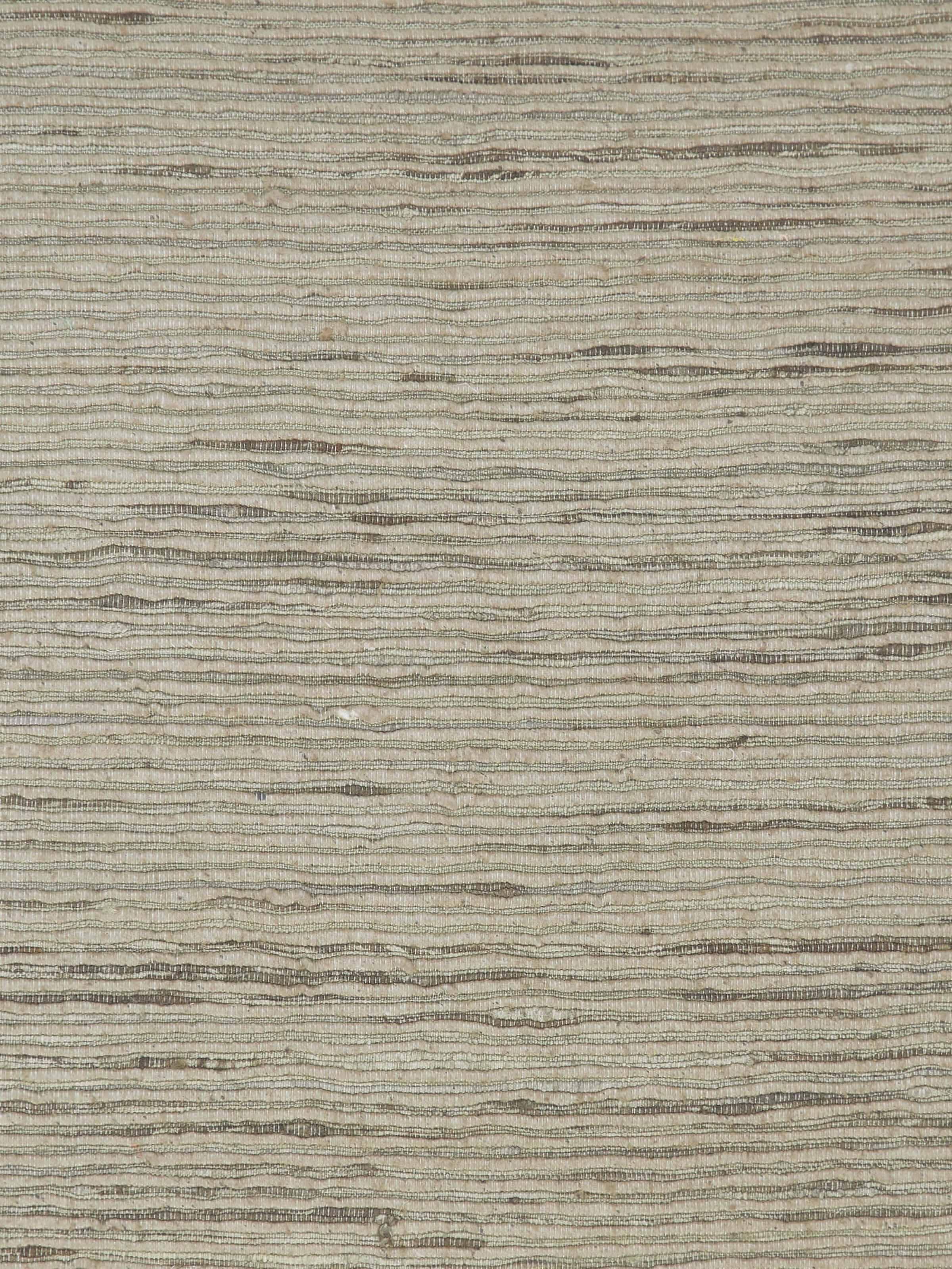 Close-up of green silk cushion edge detailing and fine handloom finish