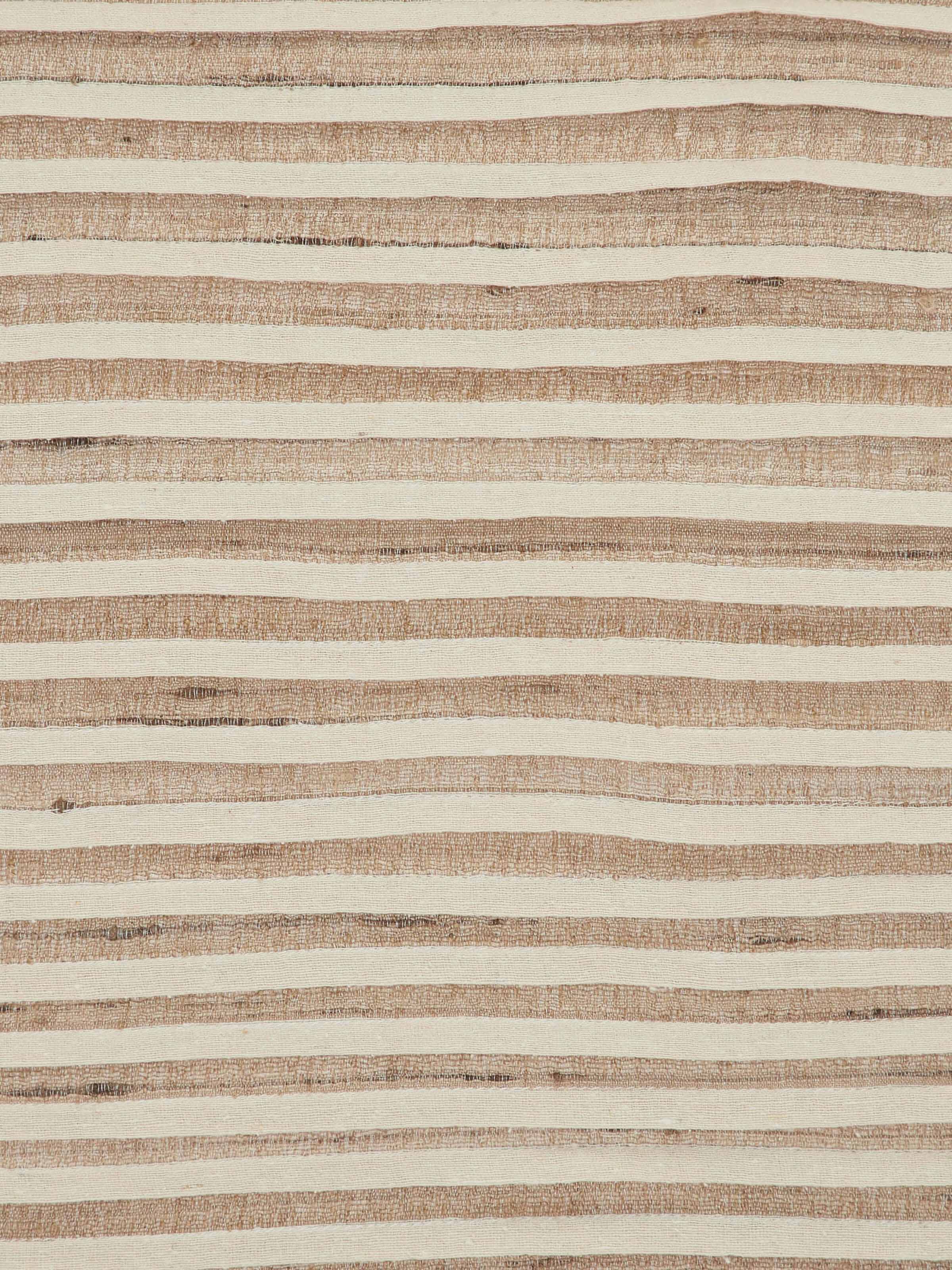 Close-up showing hemline stitching and fine cotton texture of blue stripe dinner napkins in a stack.