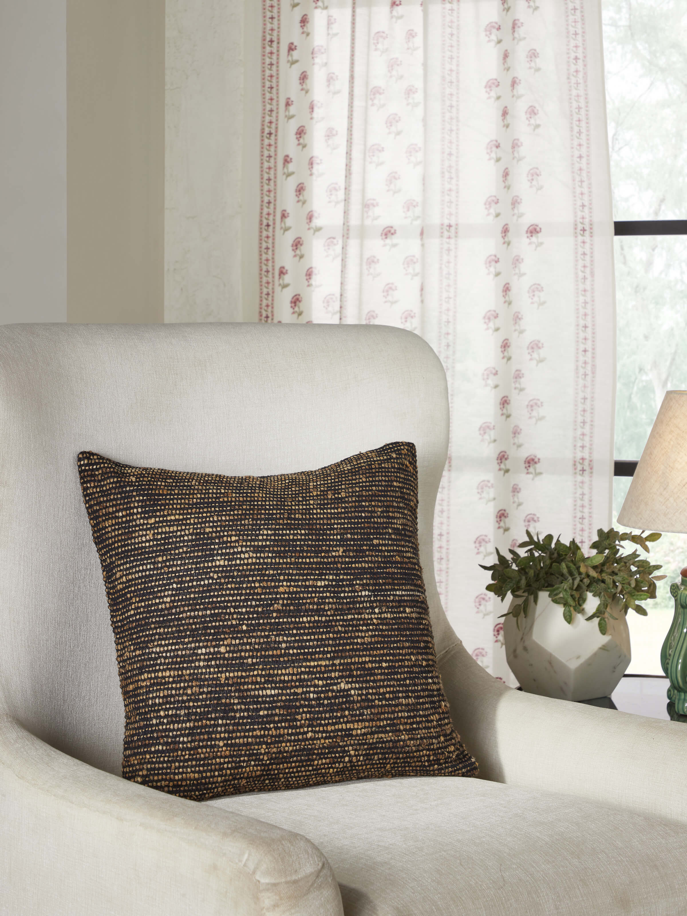 Close-up of Ujjal Black Kaya silk cushion cover highlighting the luxurious handloom fabric