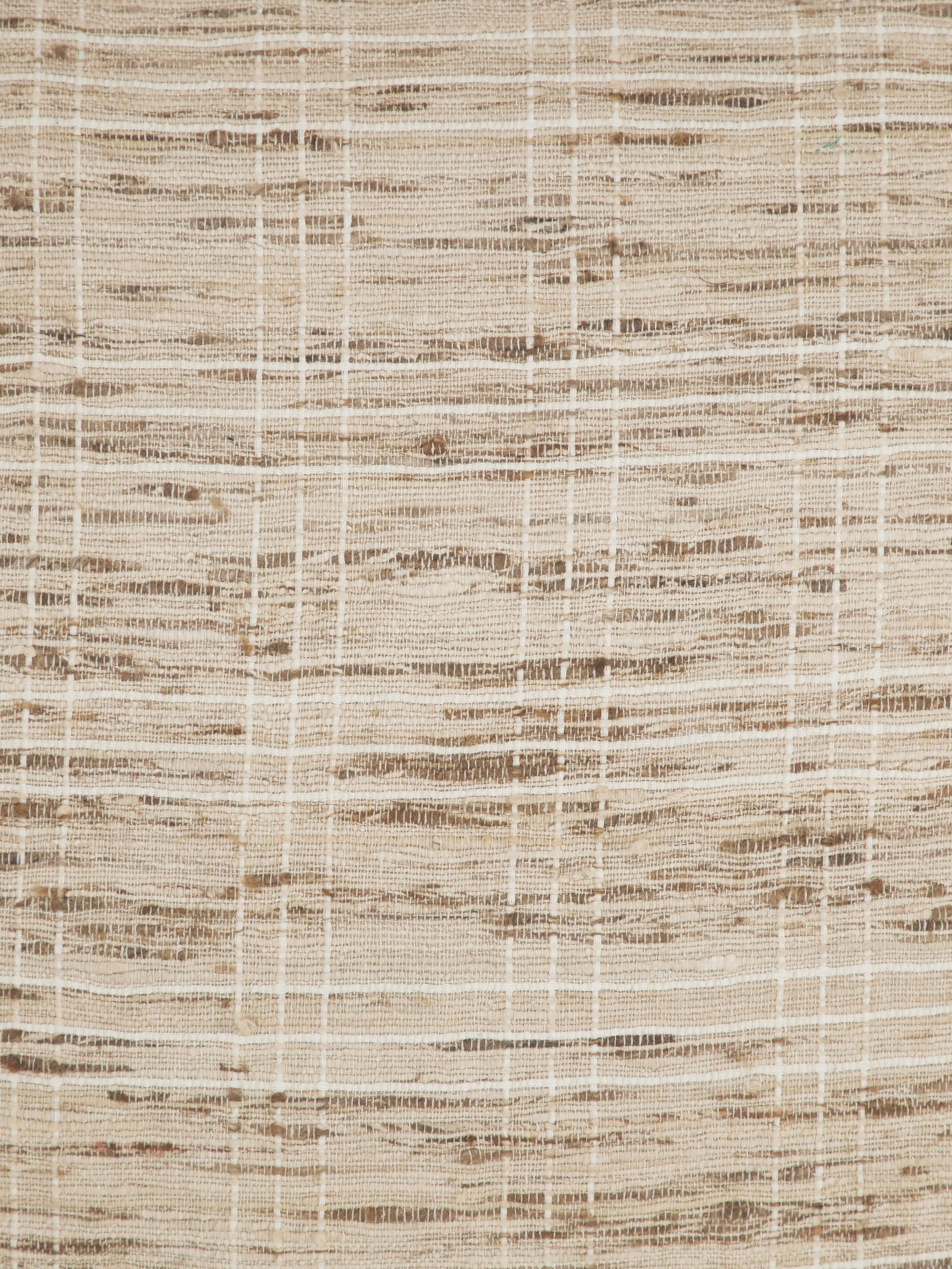 Close-up of Bhagalpur silk weave and brown checked pattern on cushion cover.