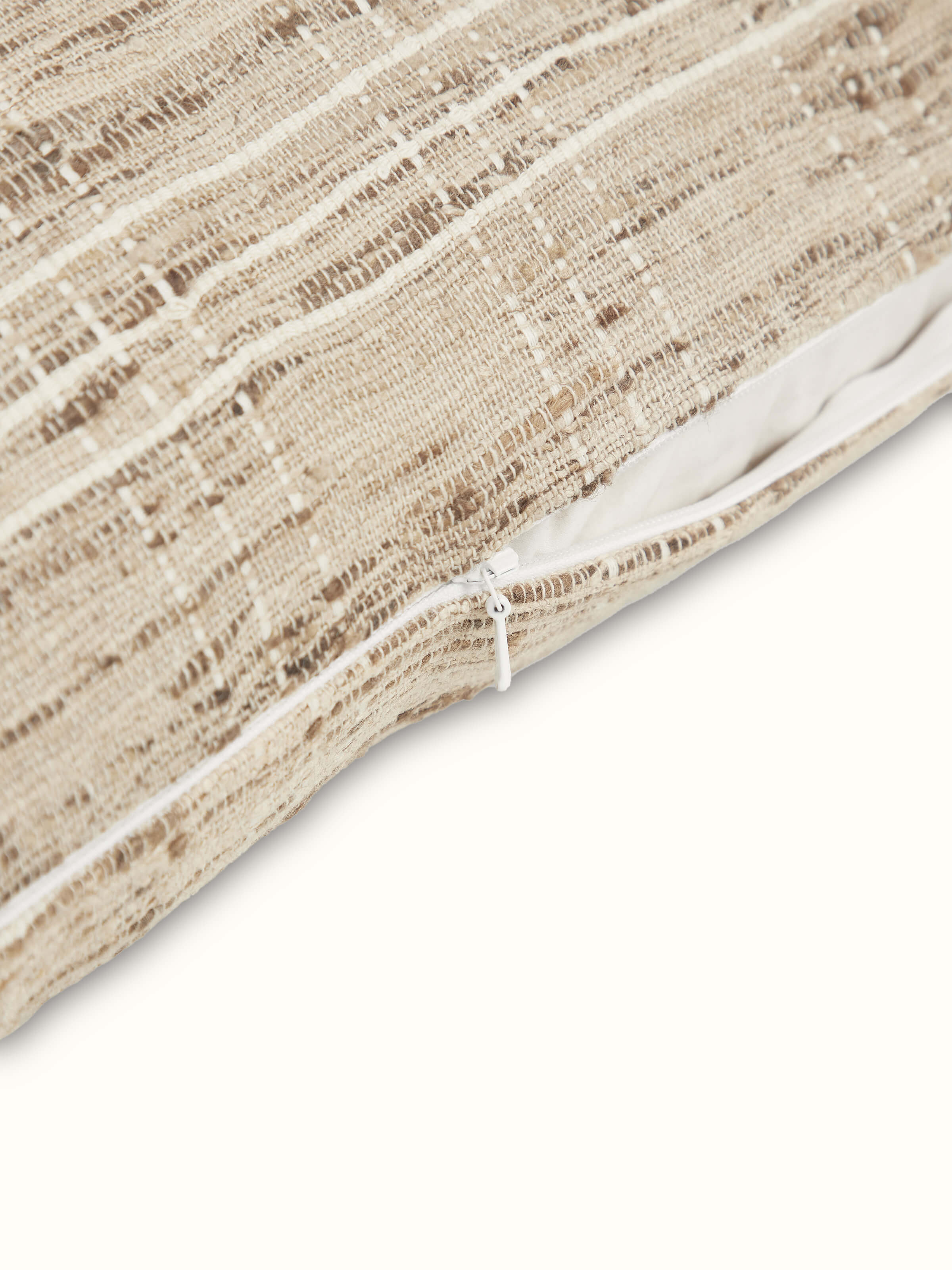 Angled view of cushion showing light reflection on handwoven silk surface.