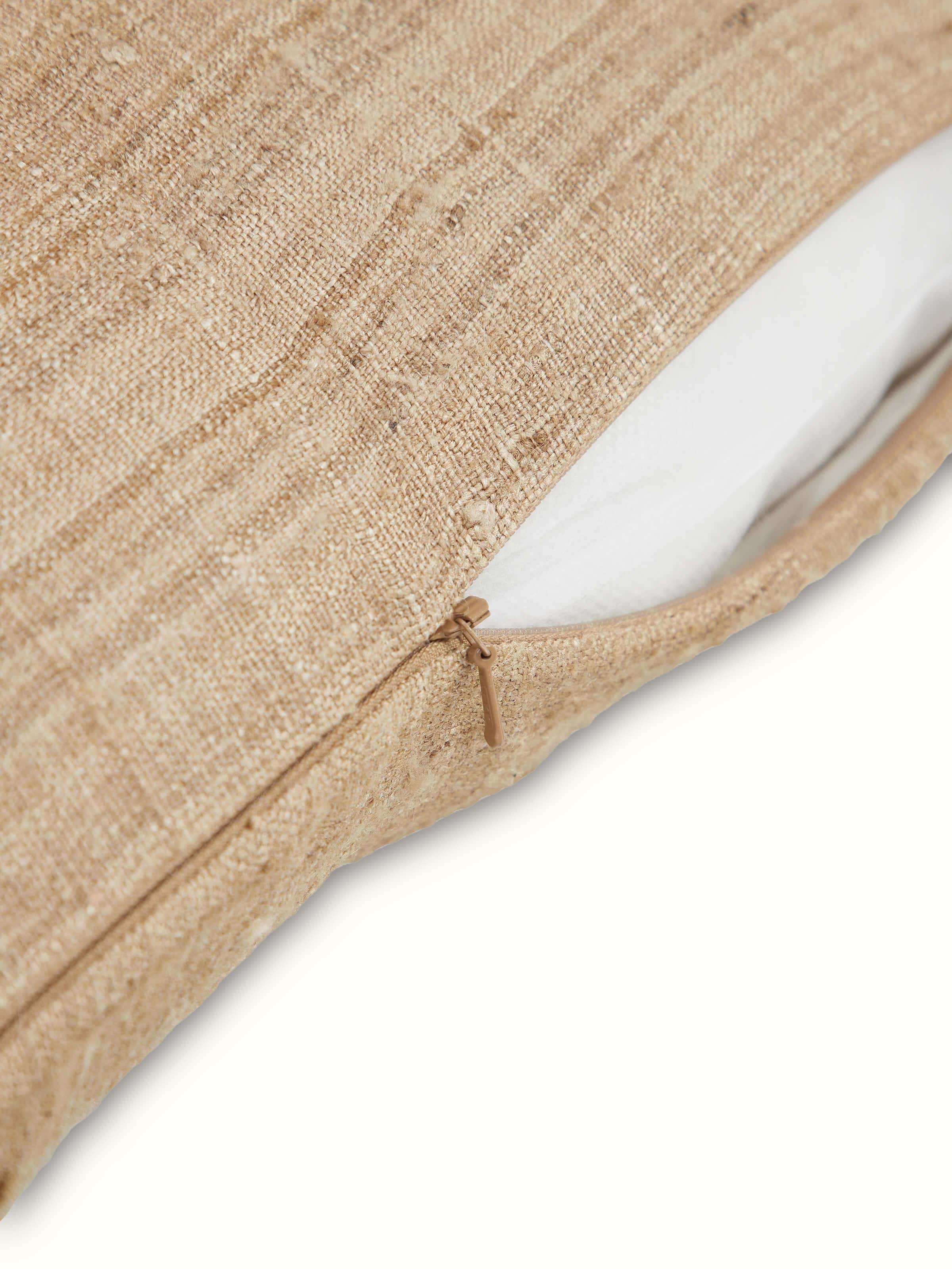 Detailed view of Ujjal brown Dharana silk slub handloom cushion cover showing the handloom craftsmanship and color depth.