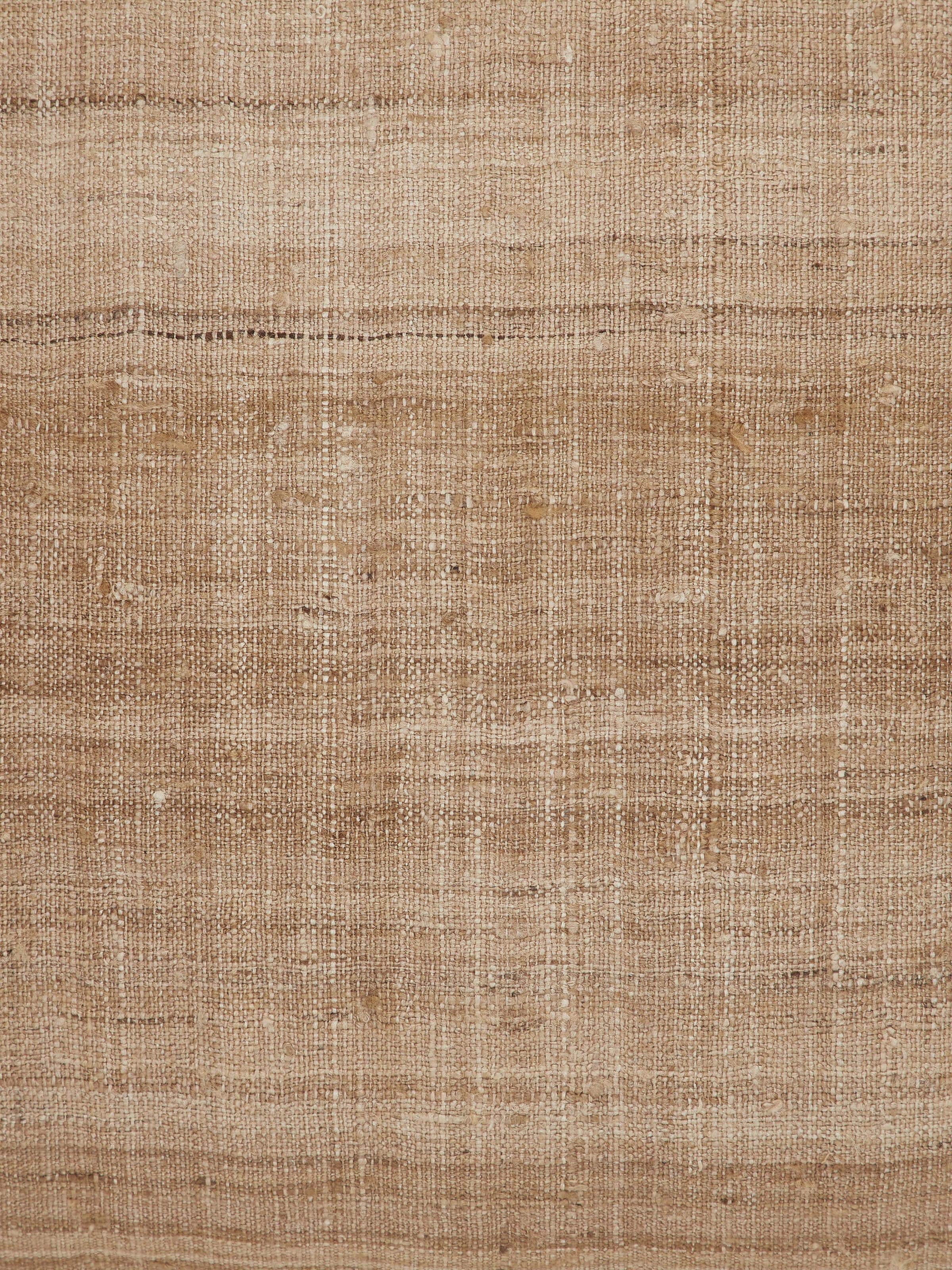 Ujjal brown Dharana silk slub handloom cushion cover in a setting, displaying its design and color integration.