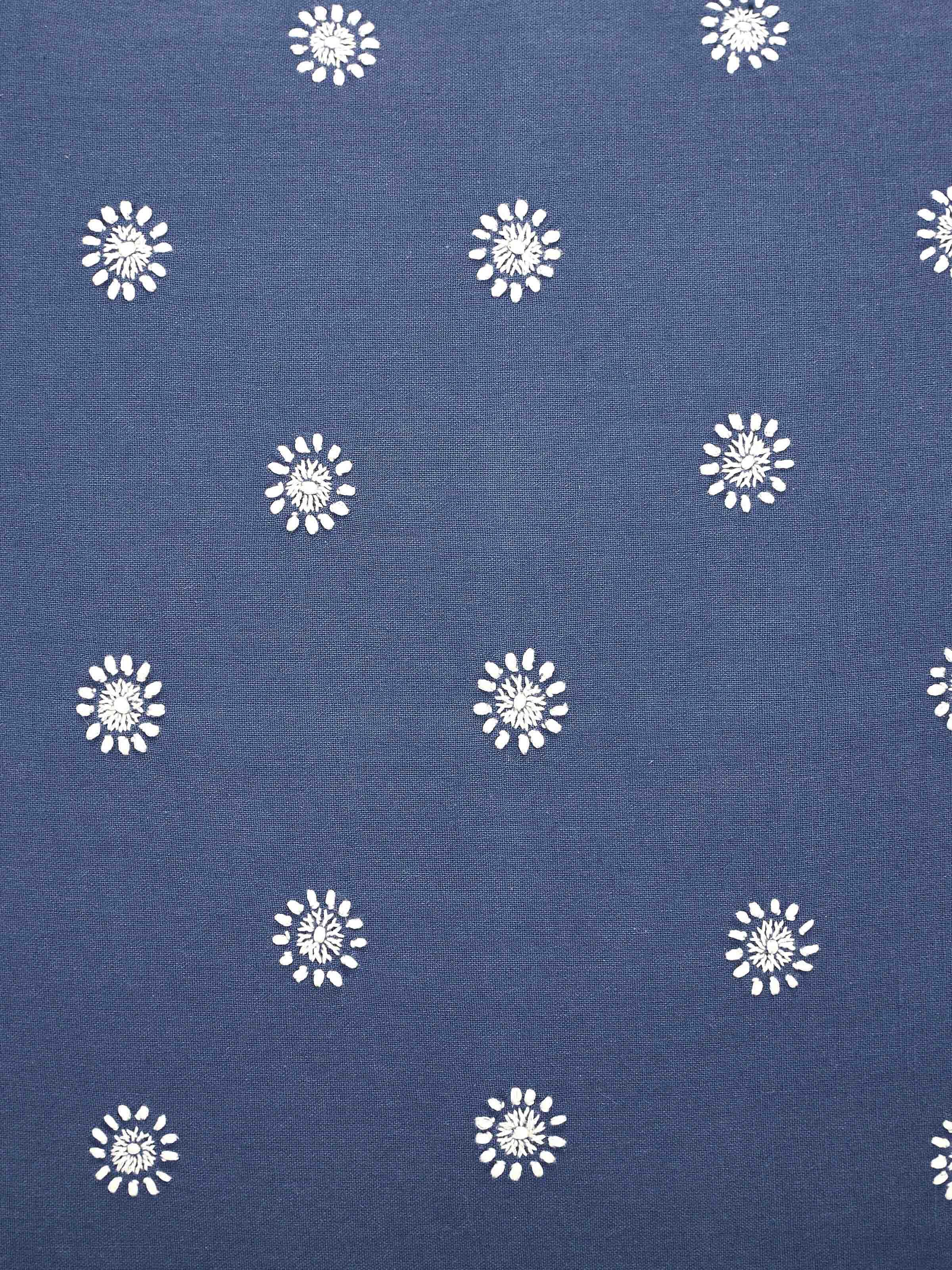 Detail shot of blue Chikankari embroidery on cotton cushion cover showcasing craftsmanship.