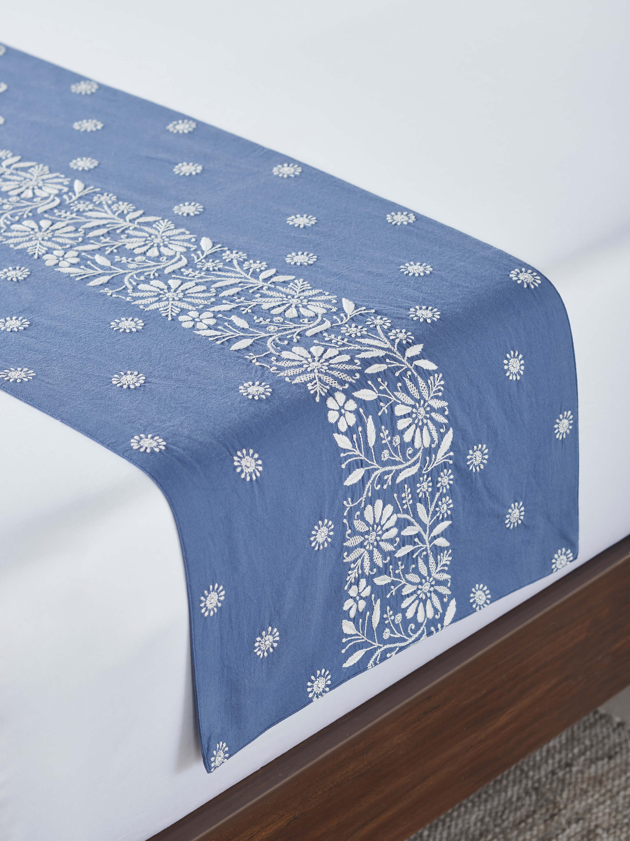 Alternate lifestyle angle of Rann linen bed runner highlighting embroidery and border.