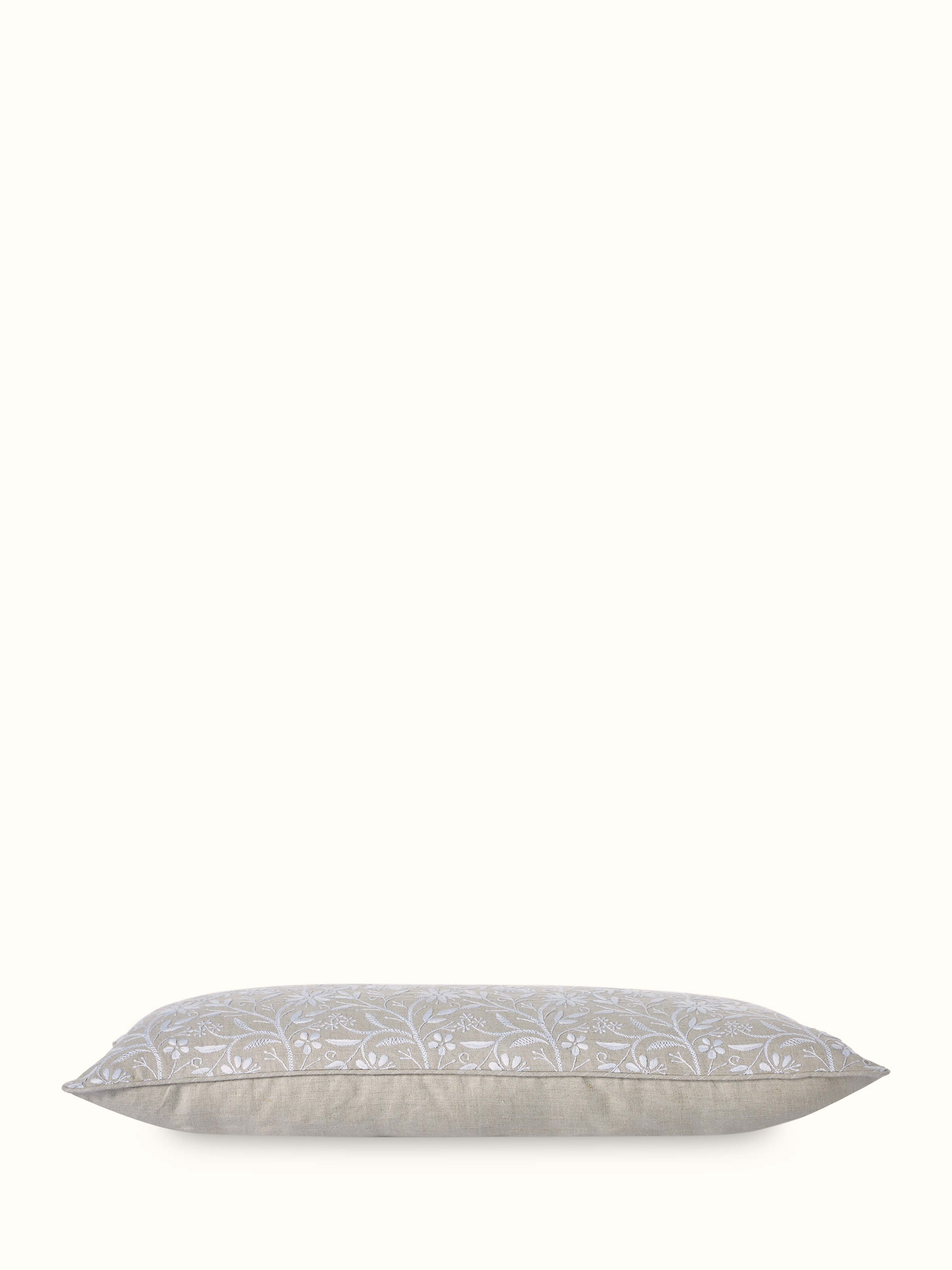 Detailed view of Rann beige allover cotton Chikankari hand embroidered cushion cover highlighting the craftsmanship of the Chikankari work.