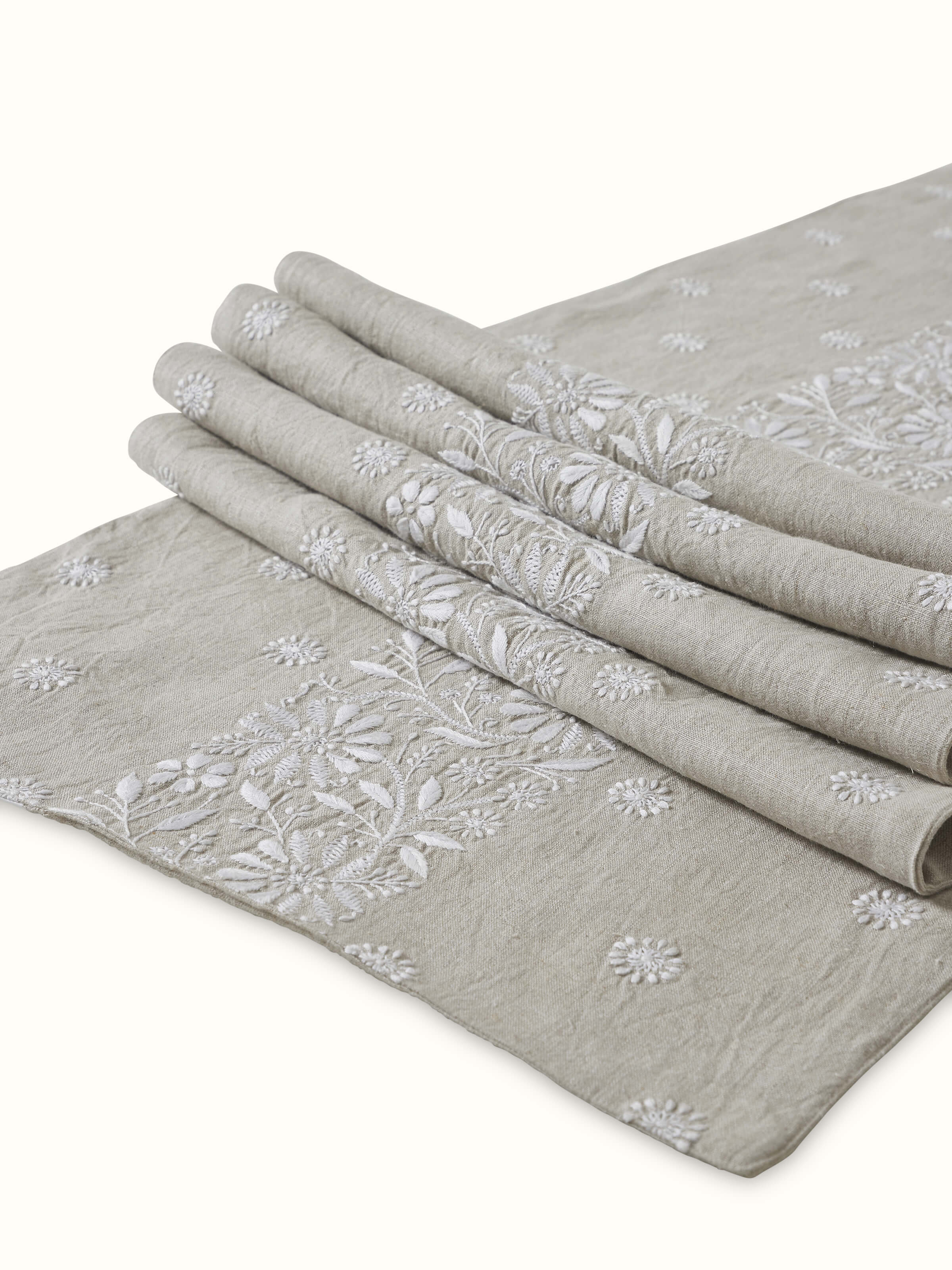 Close-up shot of hand-stitched embroidery work and fabric texture on the runner.