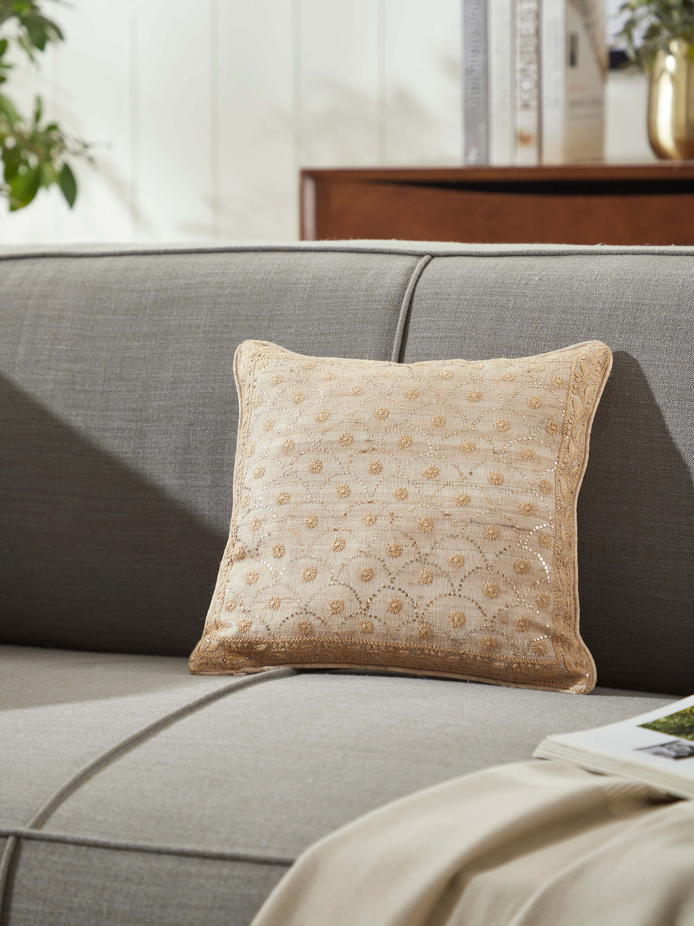 Side view of Pragya beige jaal tussar silk Chikankari hand embroidered cushion cover highlighting the embroidery
