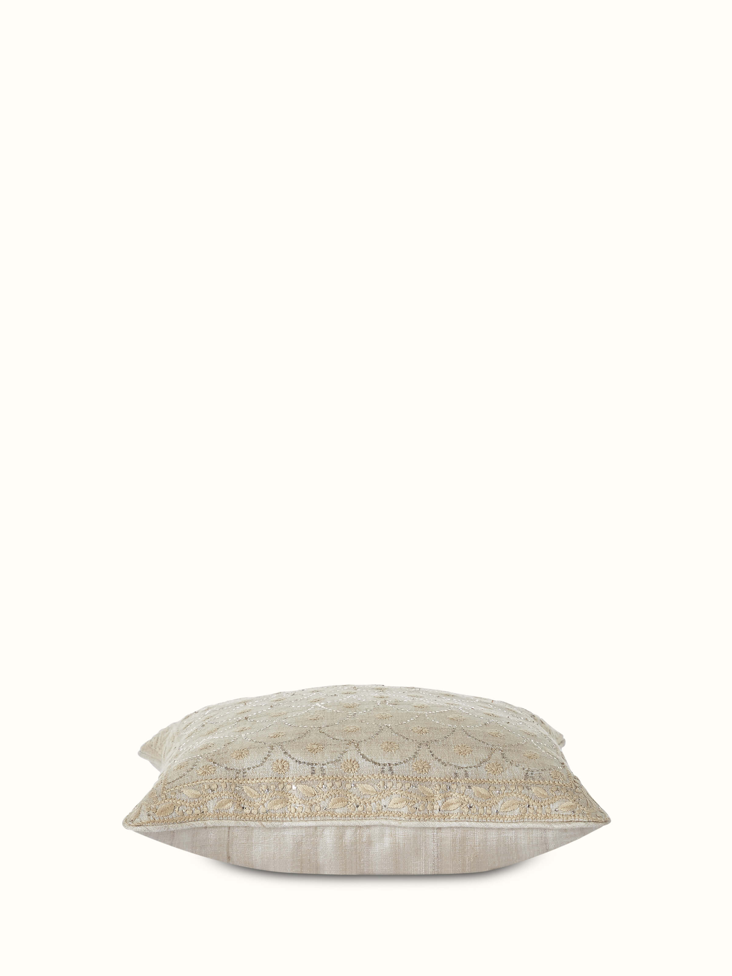 Detailed close-up of Pragya beige jaal tussar silk Chikankari hand embroidered cushion cover showing the embroidery details