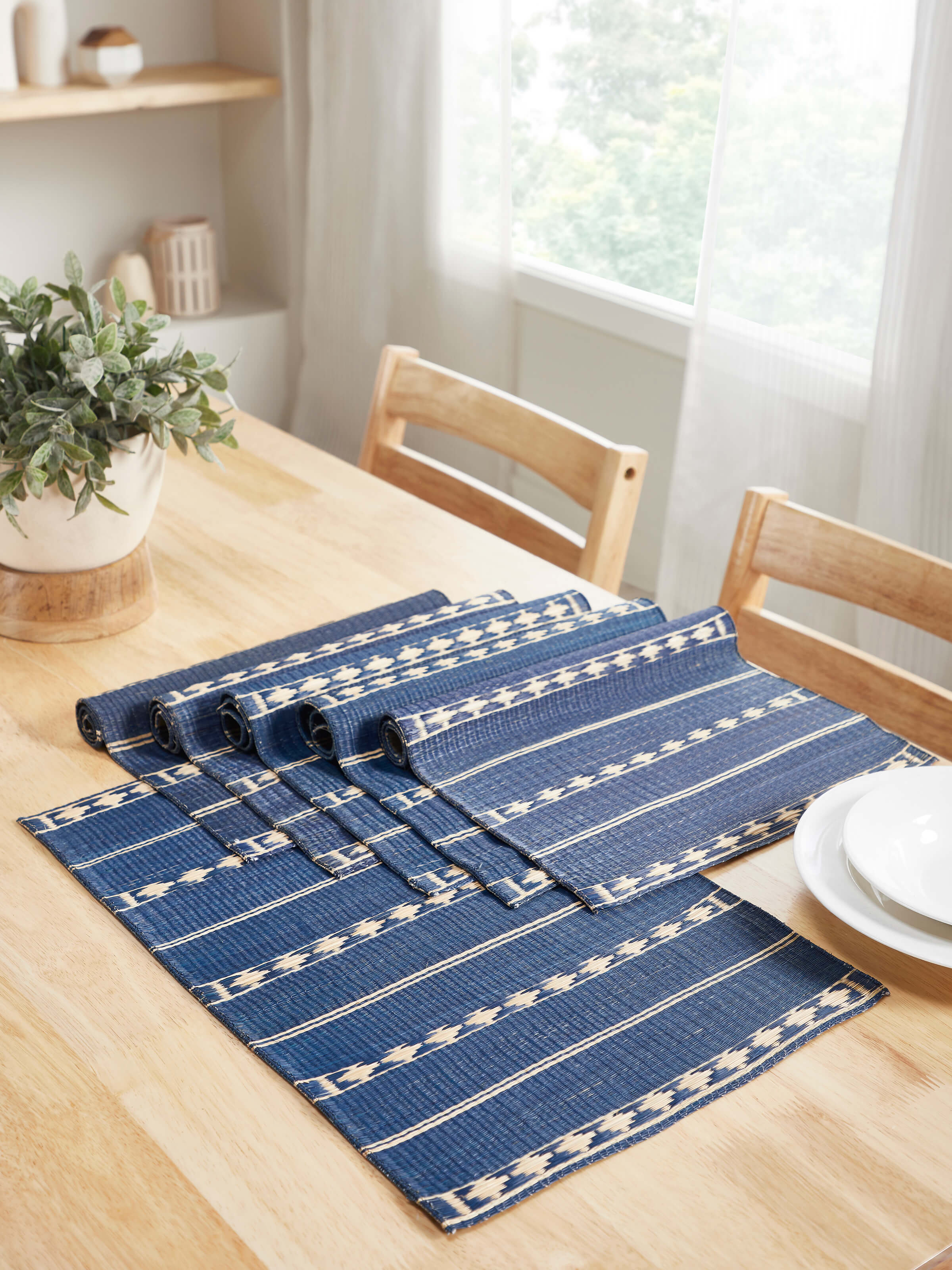 Lifestyle image of Prakriti Madurkathi Mats arranged on a dining table, showcasing sustainable style.