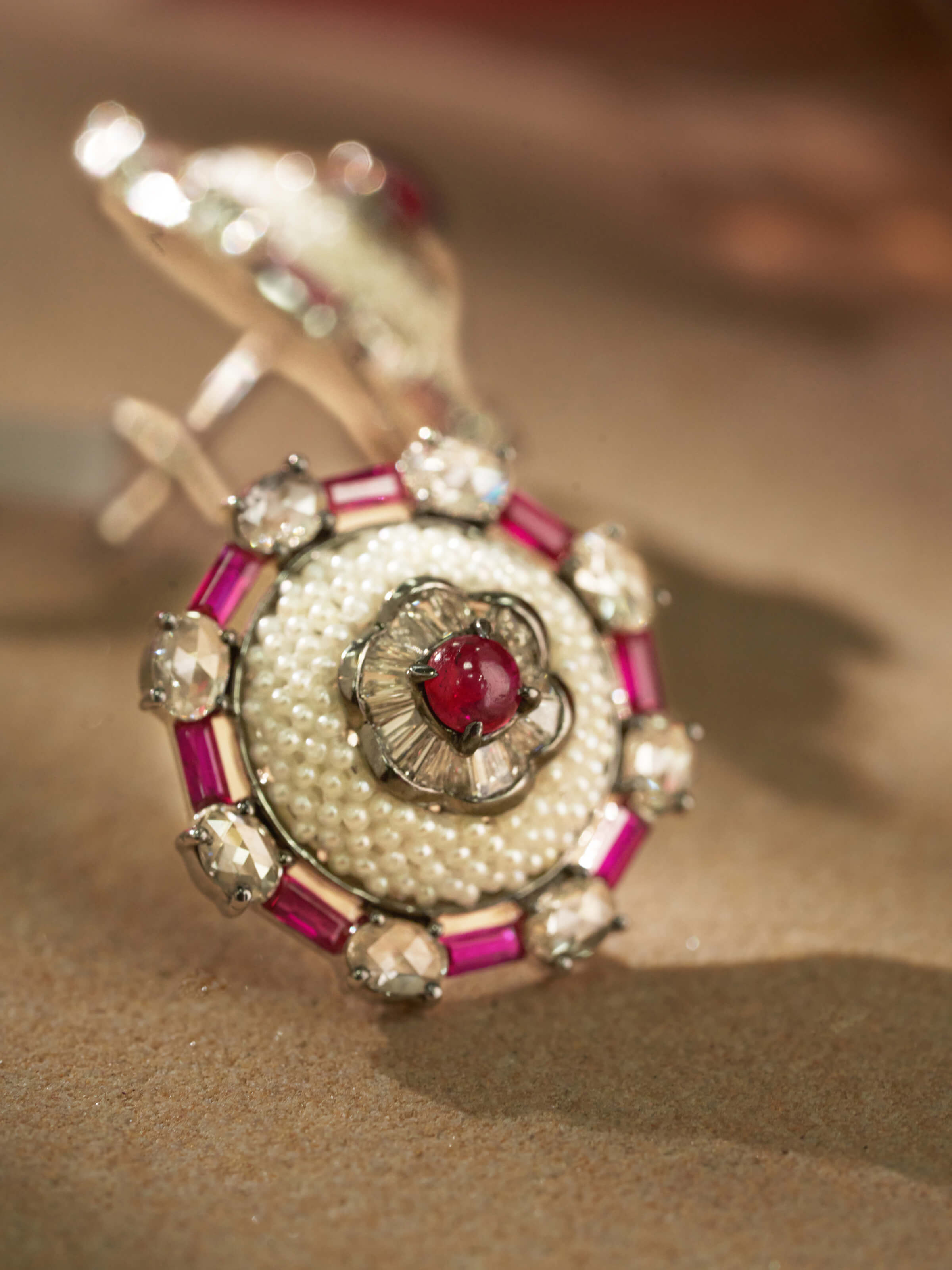 Side view of Pearl Pirohi 18 Karat Gold Studs by Swadesh focusing on the detailed gold craftsmanship and pearl design