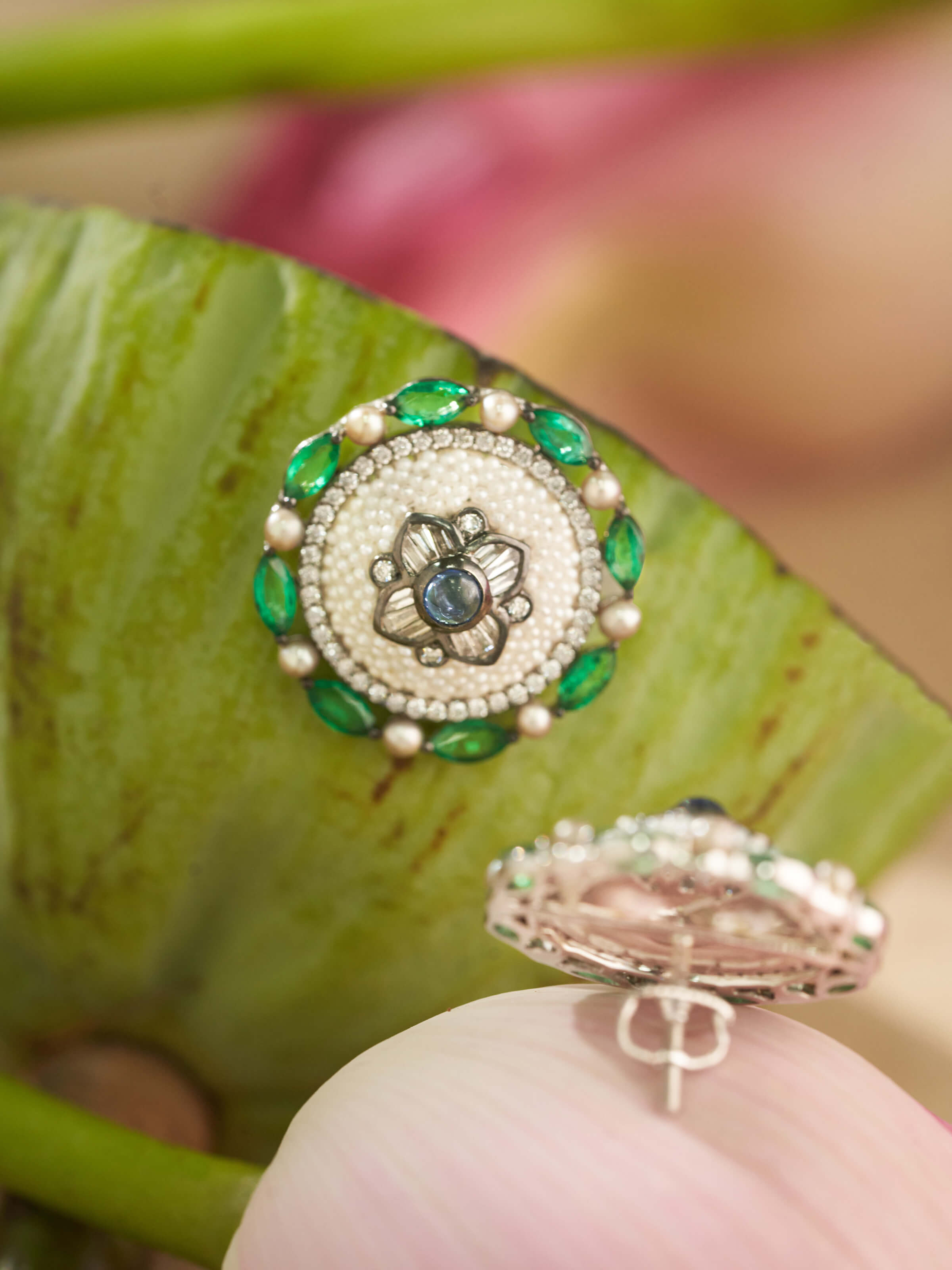 Angled view of Pearl Pirohi 18K gold studs showing pearl profile and delicate gold petal details.