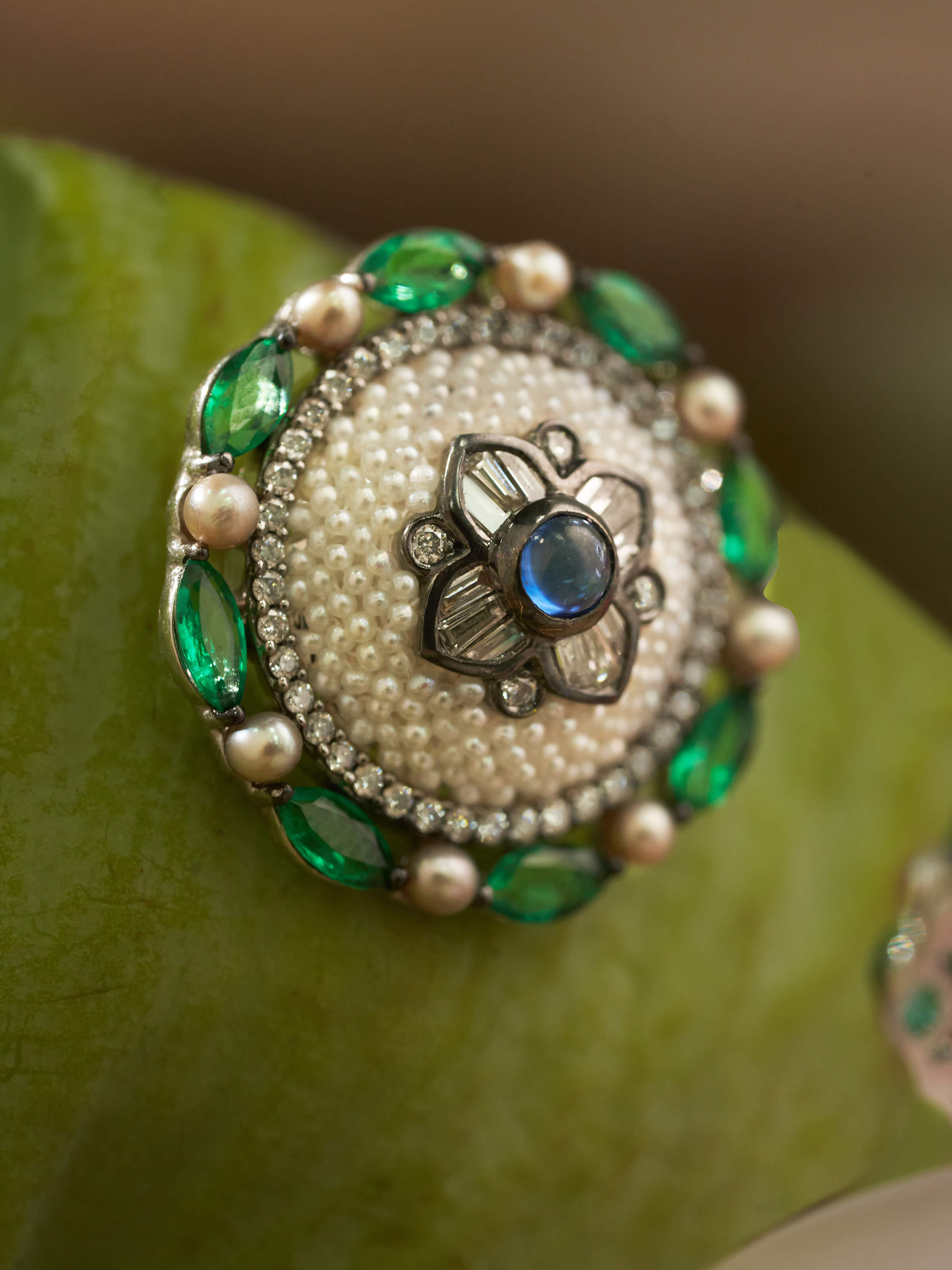 Detail close-up of Pearl Pirohi gold studs highlighting lustrous pearl and textured gold finish.