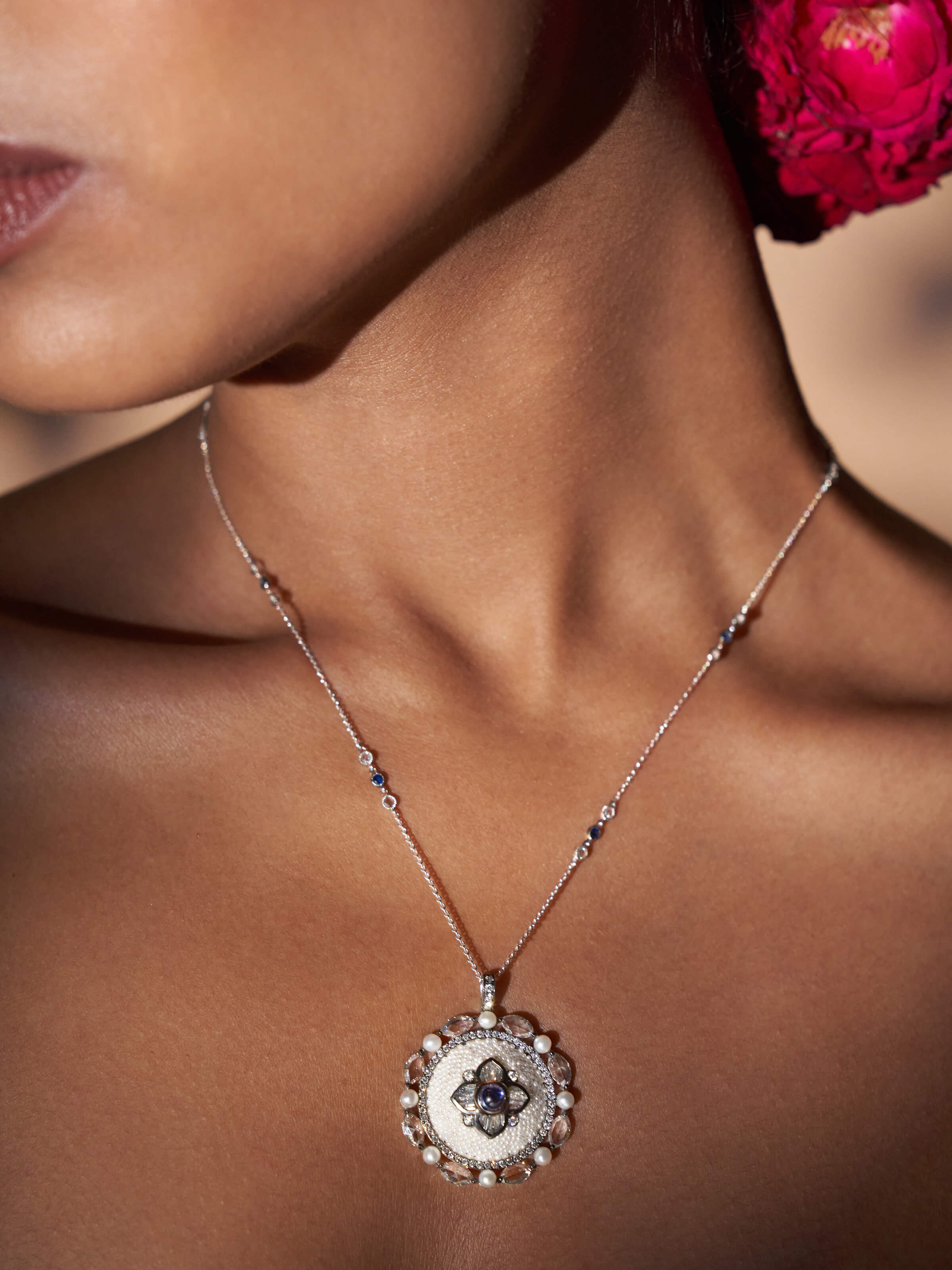 Close-up highlighting the pendant’s intricate gold and pearl work