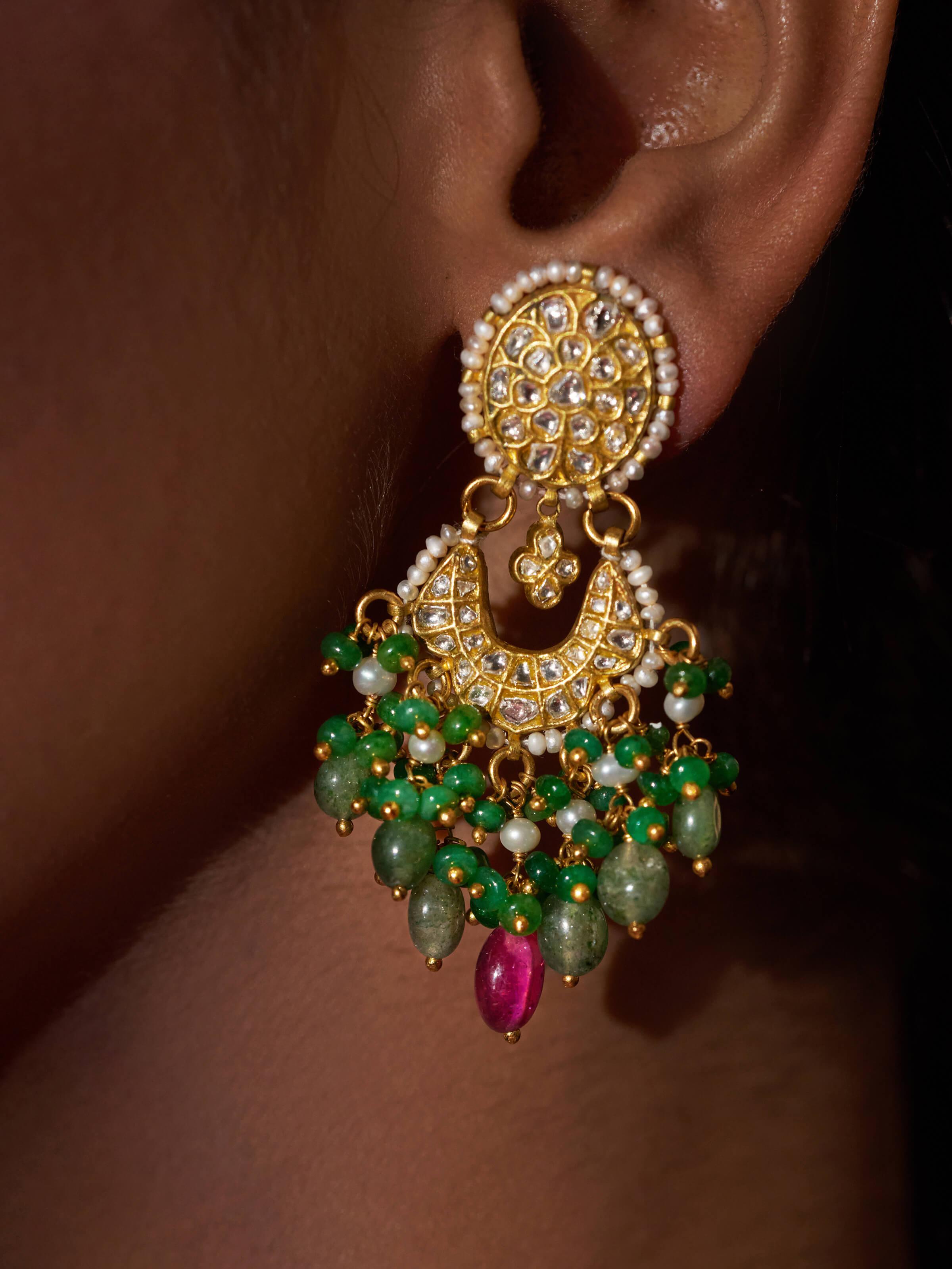 Detailed view of Thappa 22 karat gold drop earrings emphasizing traditional gold design