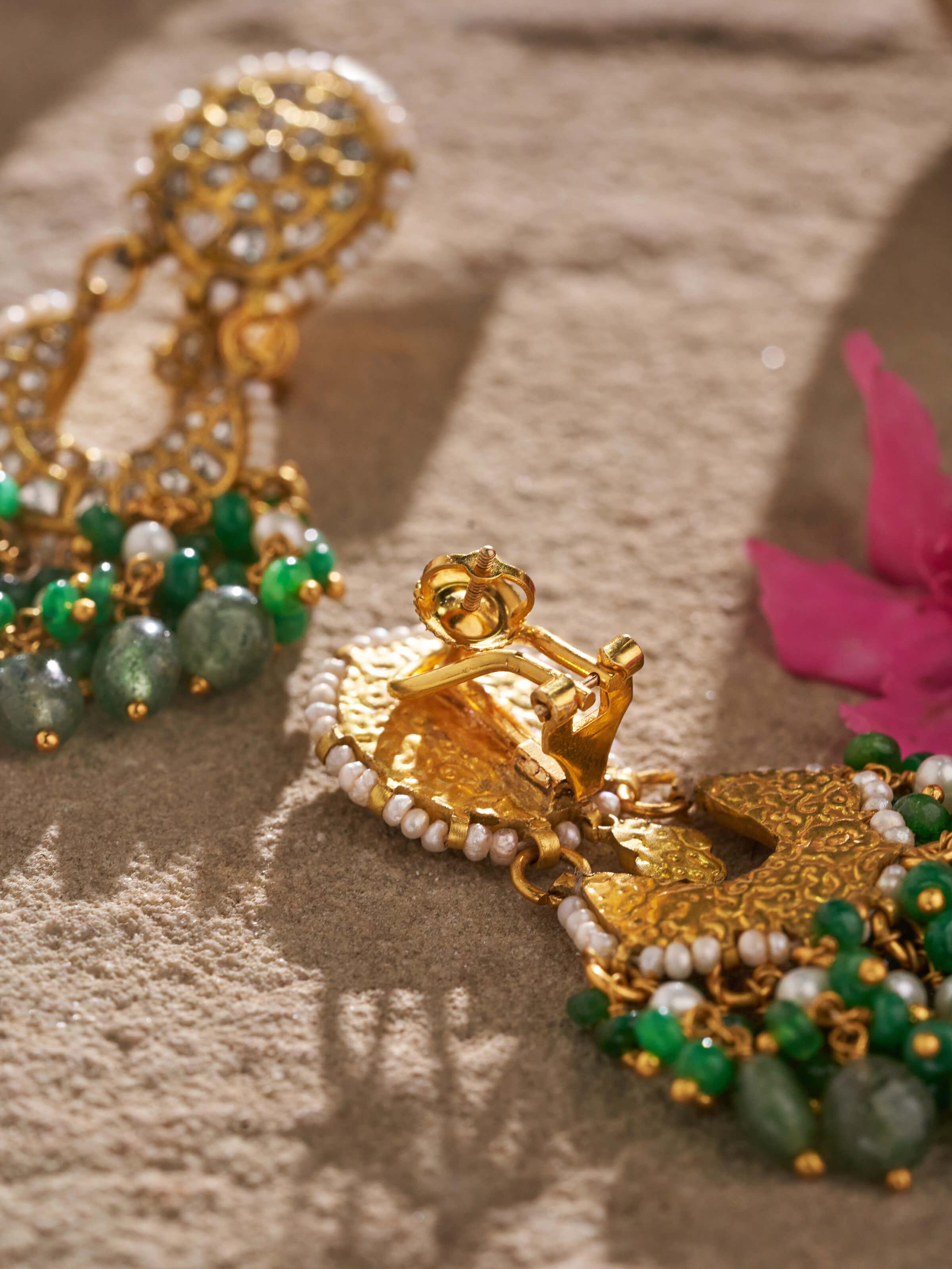 Overhead view of Thappa 22 karat gold drop earrings displaying their elegant drop shape