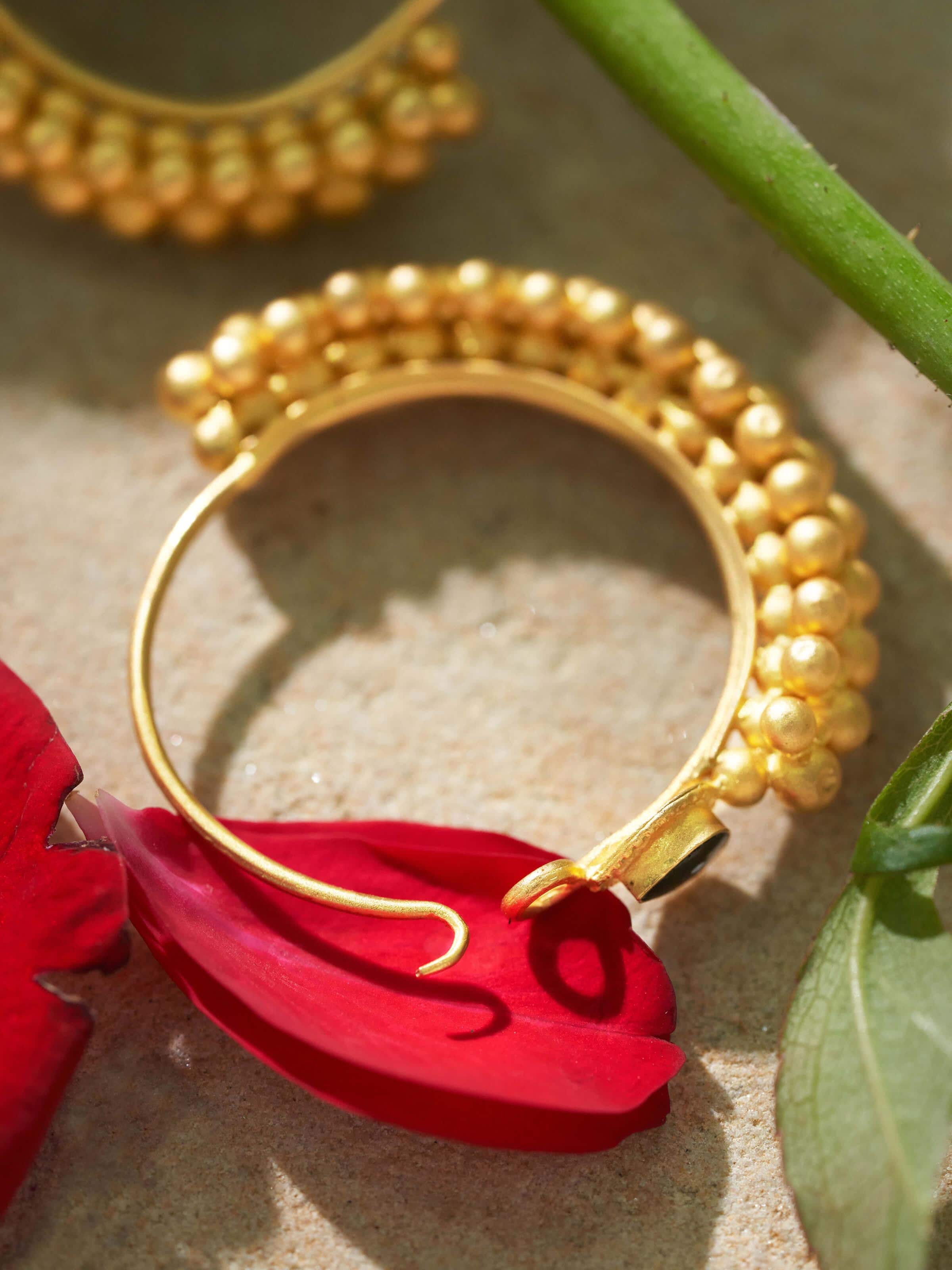 Back view of gold hoop earrings showing clasp design and smooth rear surface