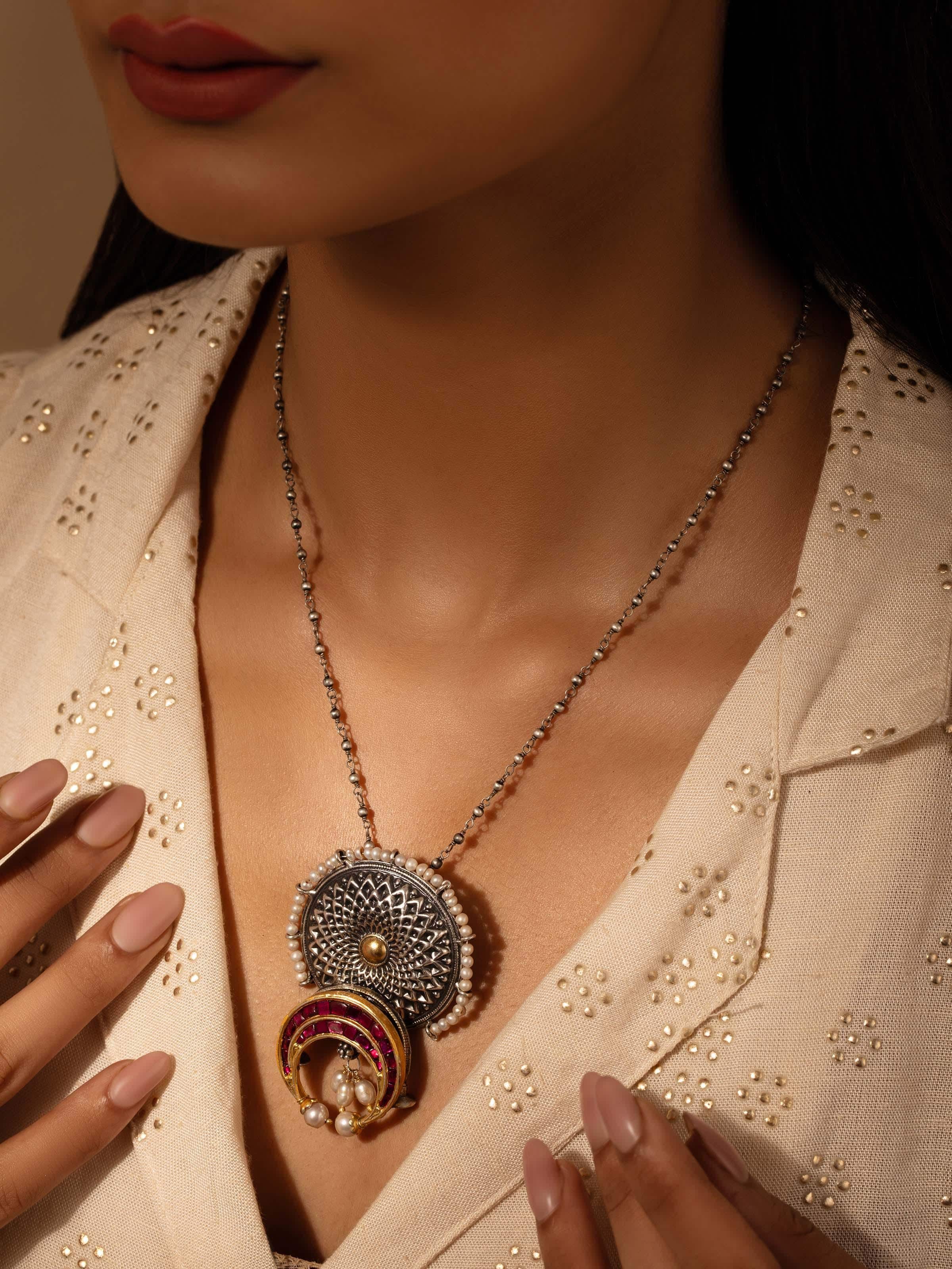 Side view of silver smithing pendant & chain highlighting the intricate craftsmanship