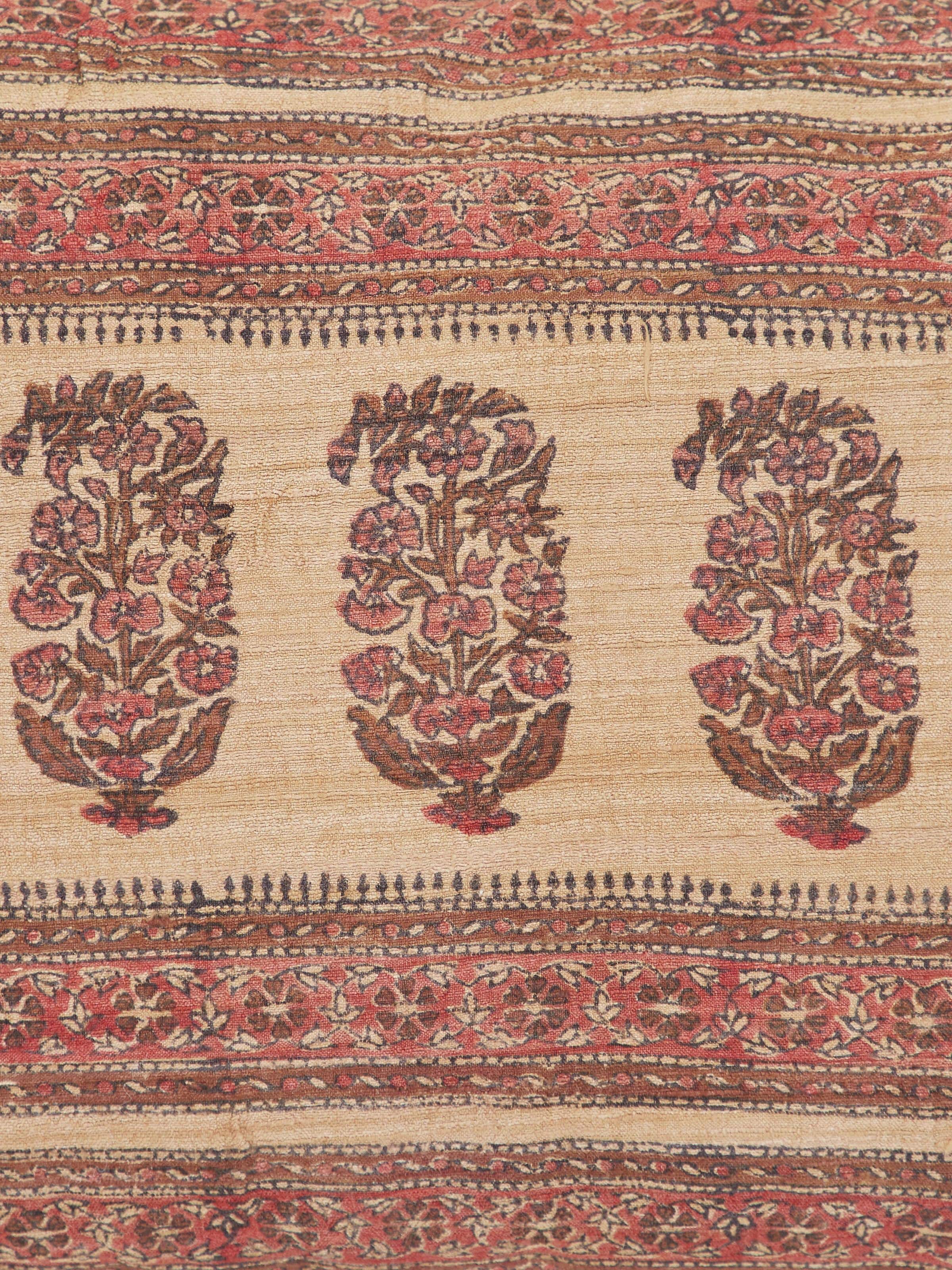 Vasudha rust stripe tussar silk Bagru hand block print cushion cover arranged to show its full design and color.