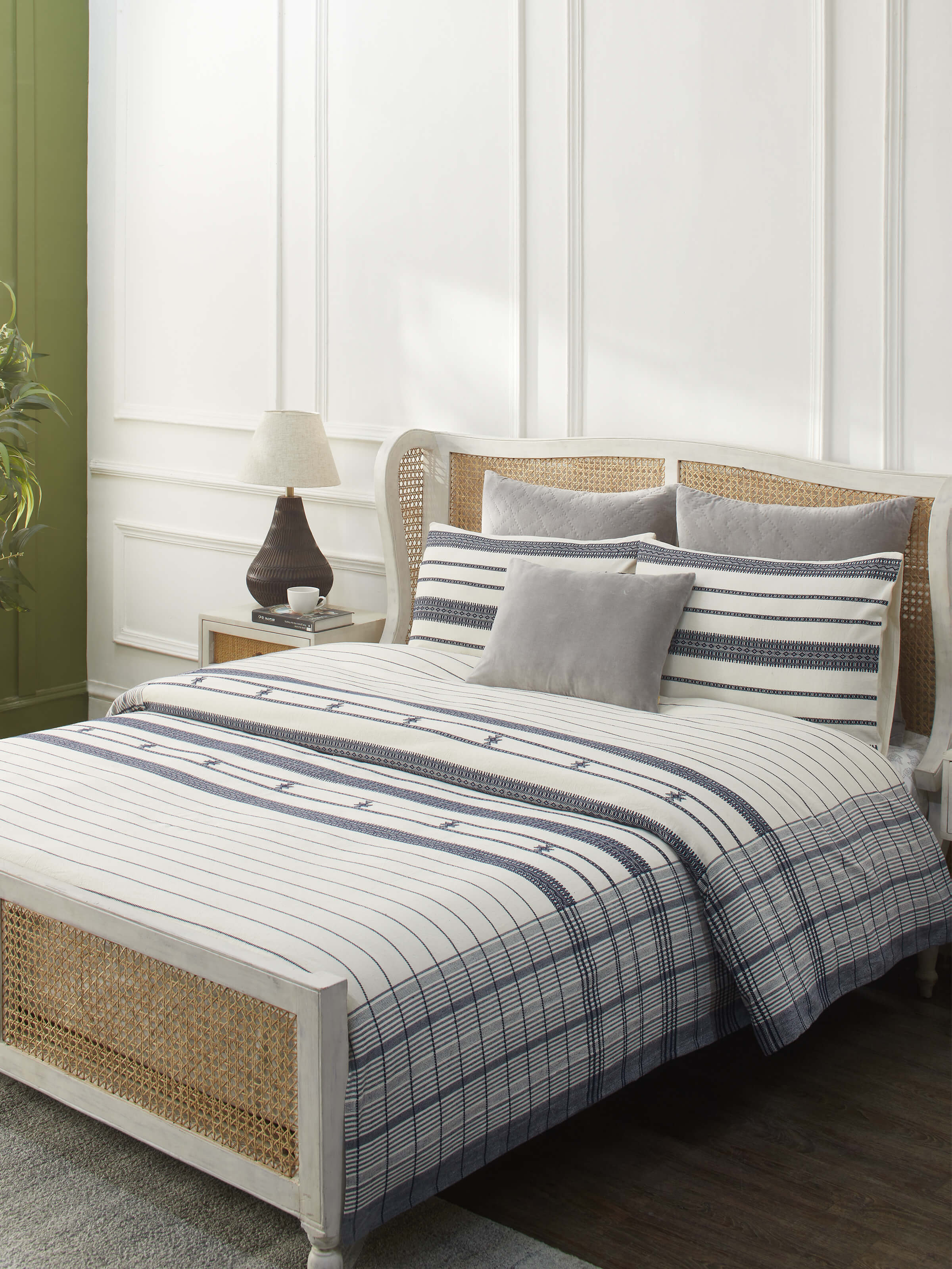 Lifestyle shot of Adalaj Blue Stripe Cotton Bhujodi Extra-Weft Queen Bedspread Set (3 pcs) on a bed.