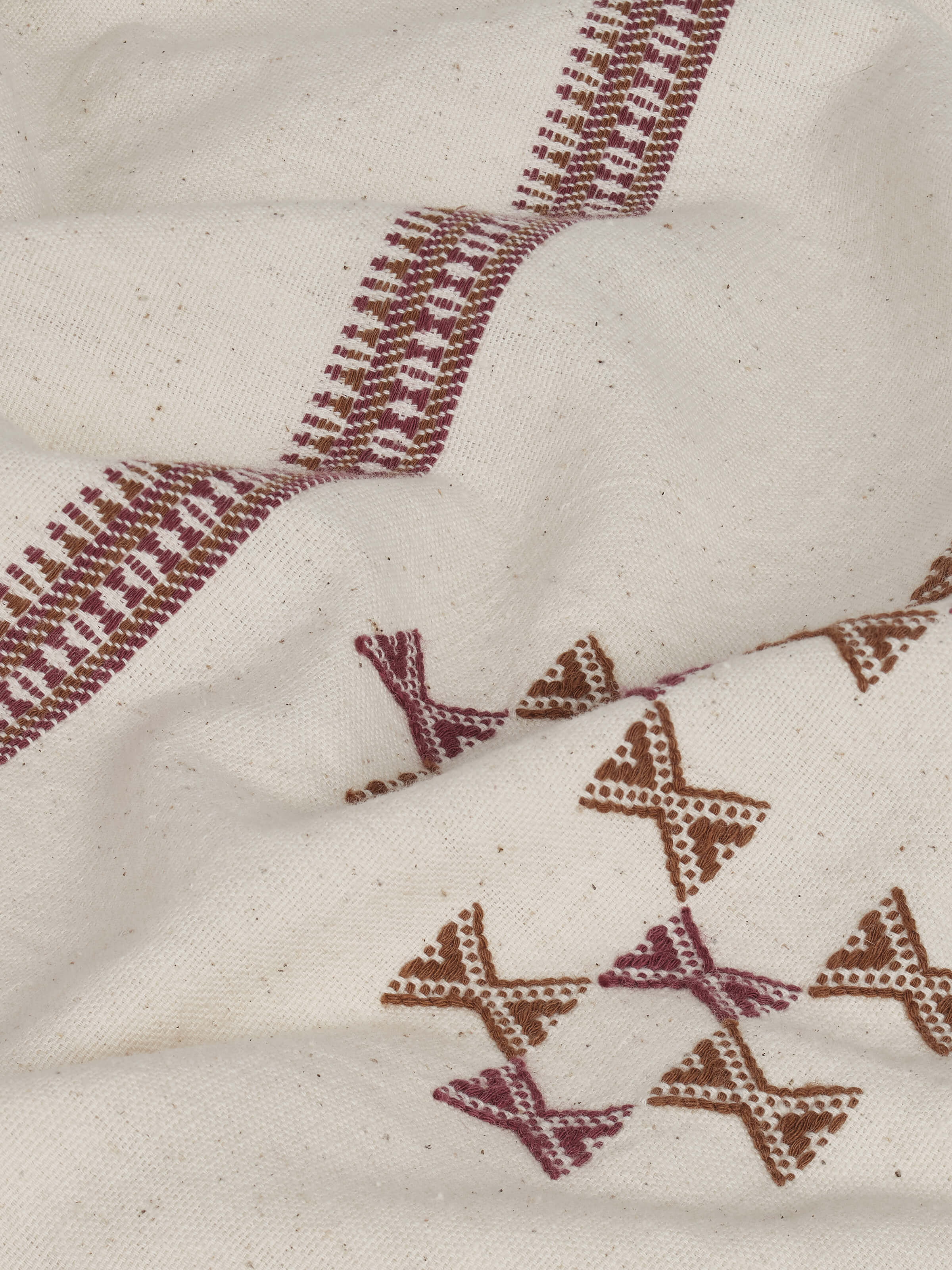 Detail view of the extra-weft weave of Adalaj pink geometric cotton Bhujodi bedspread