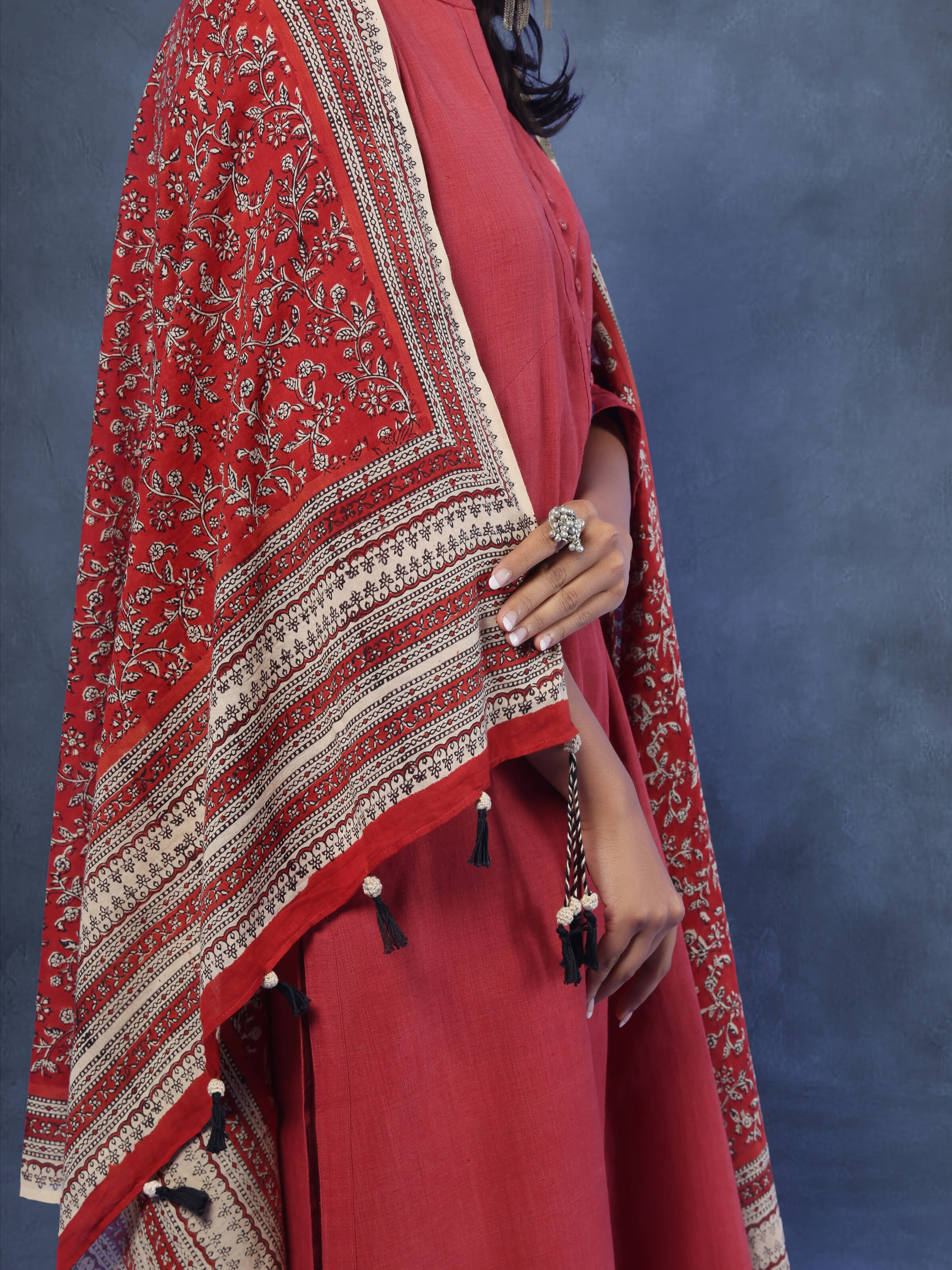 Angled view of red and beige cotton dupatta showing intricate Bagru block print detail.