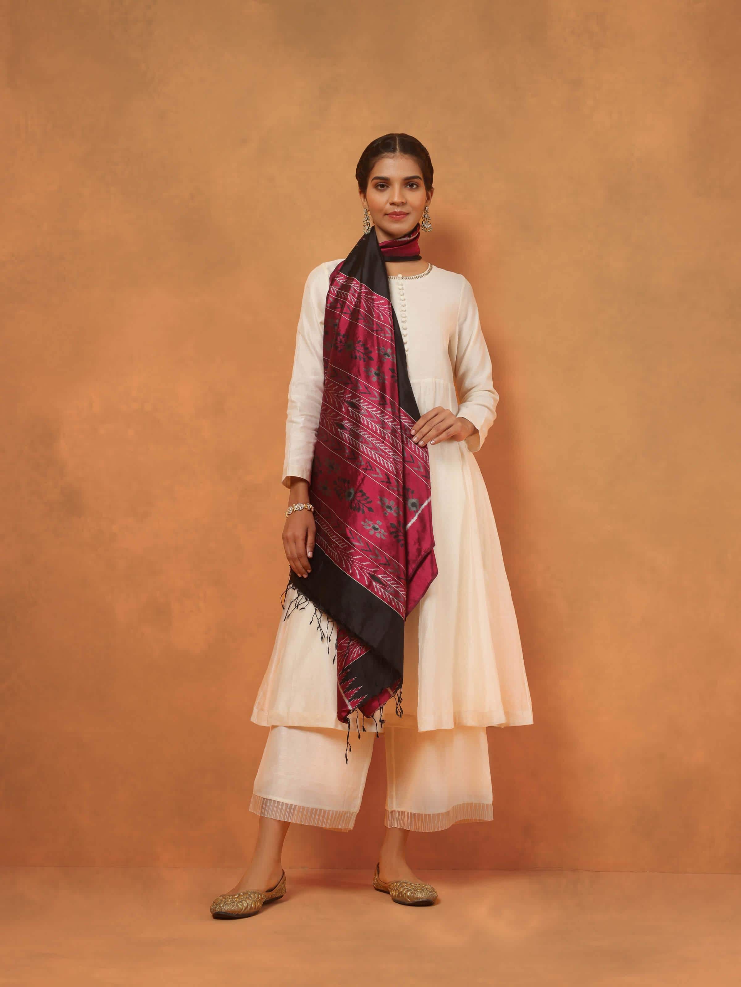 Pink and black silk Odisha Ikat dupatta lifestyle view draped over model showcasing fabric sheen and print