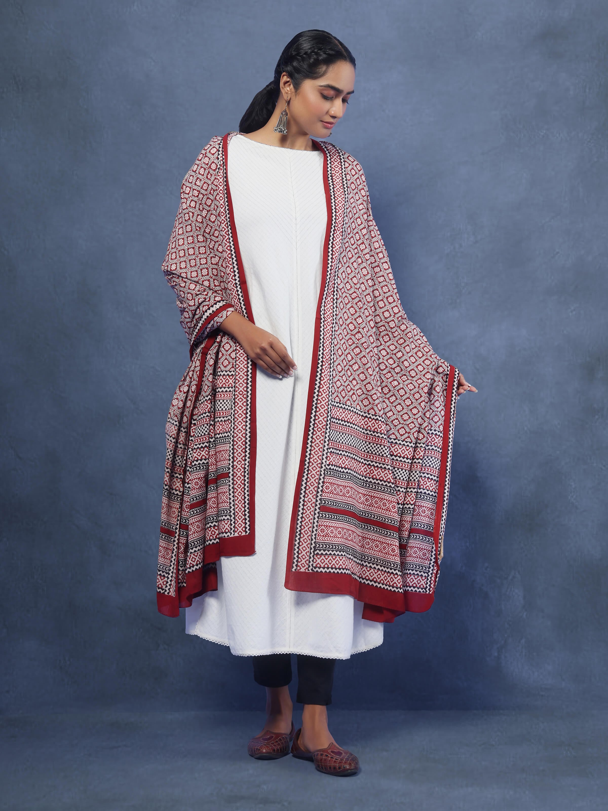 Lifestyle view of red Bagh print dupatta draped with ethnic attire for a vibrant look