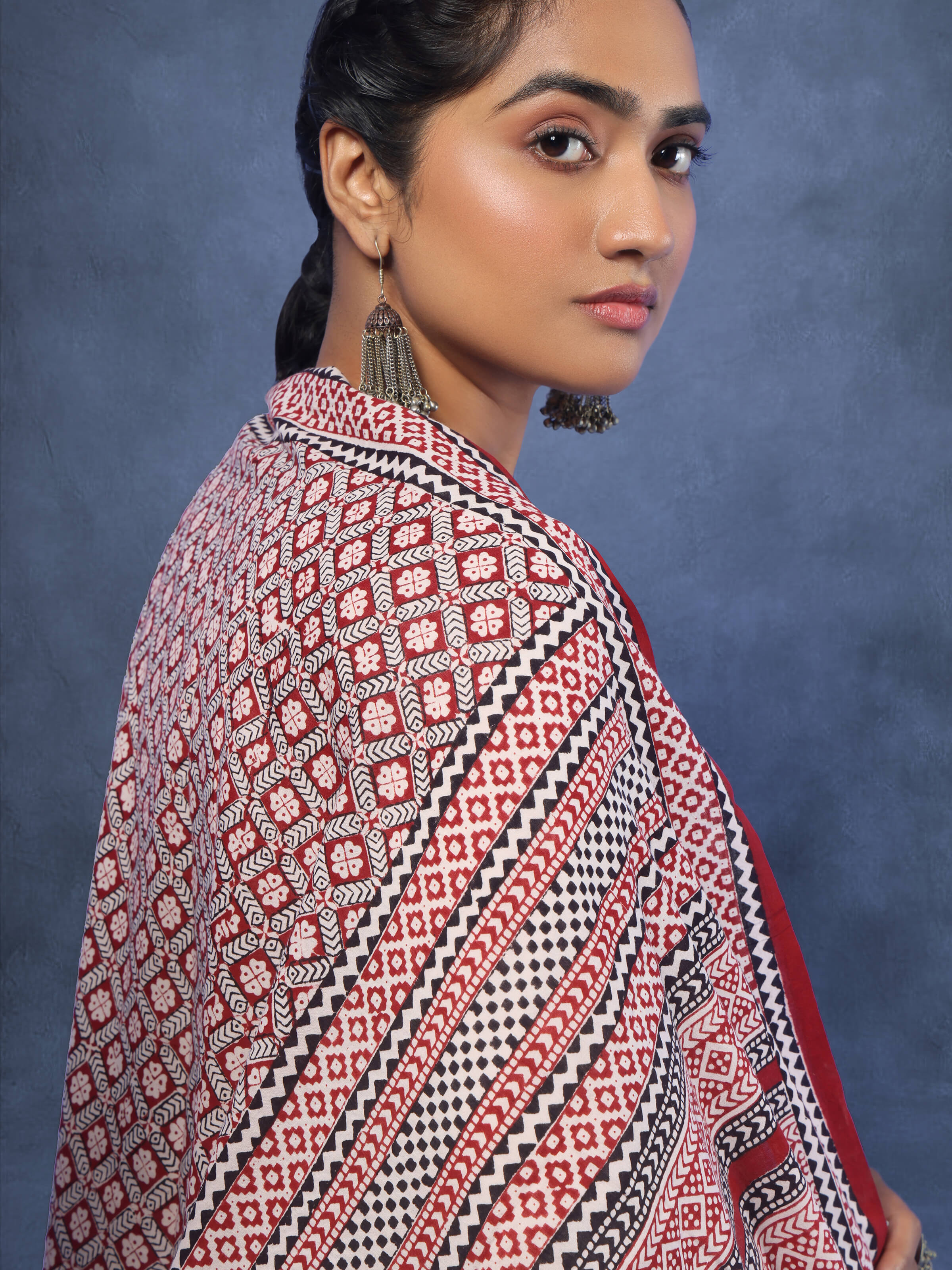 Angled view of red cotton dupatta showcasing full Bagh print and bold color palette