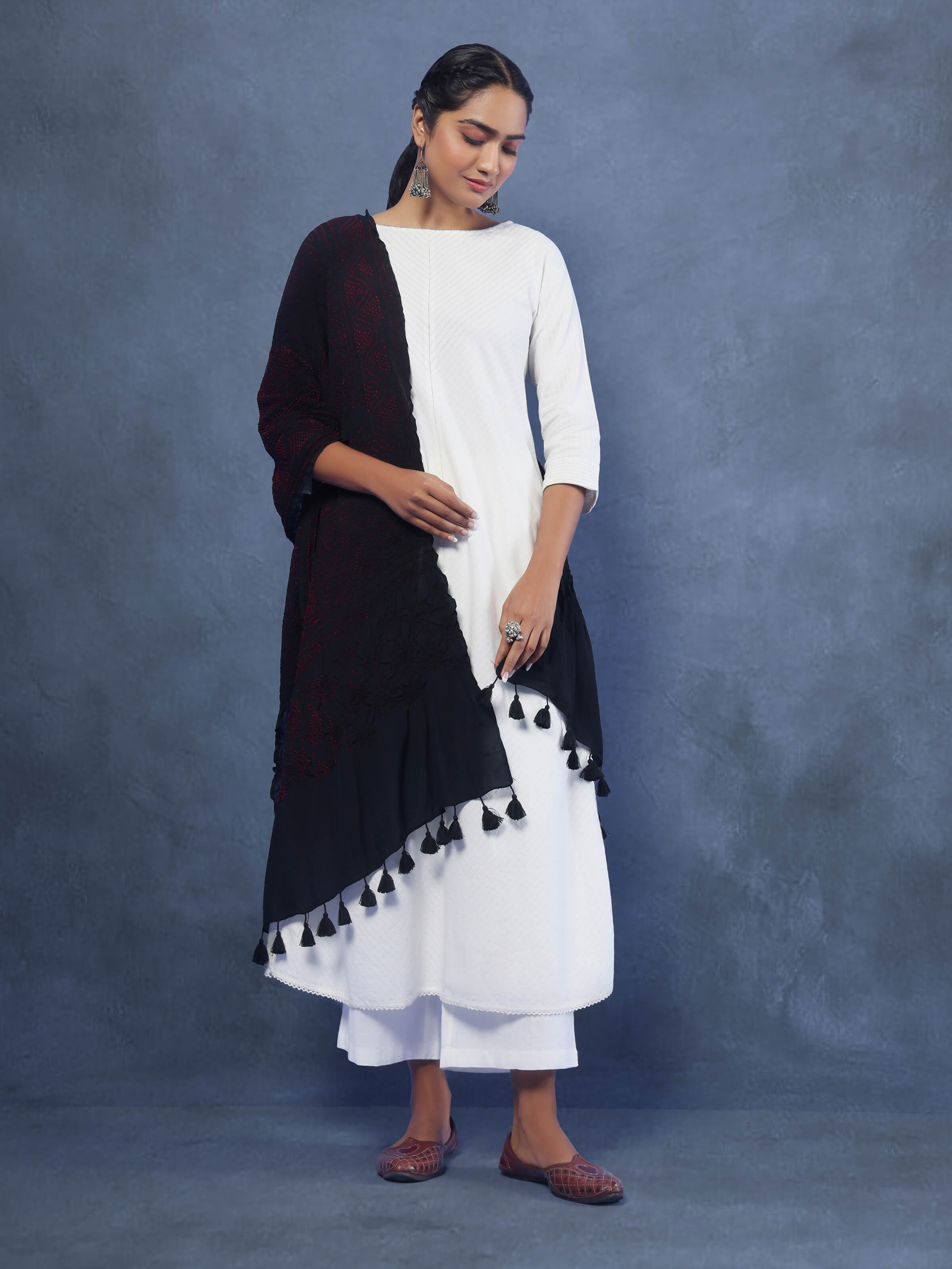 Model draped in red Bandhani silk dupatta with intricate tie & dye design and elegant flow.