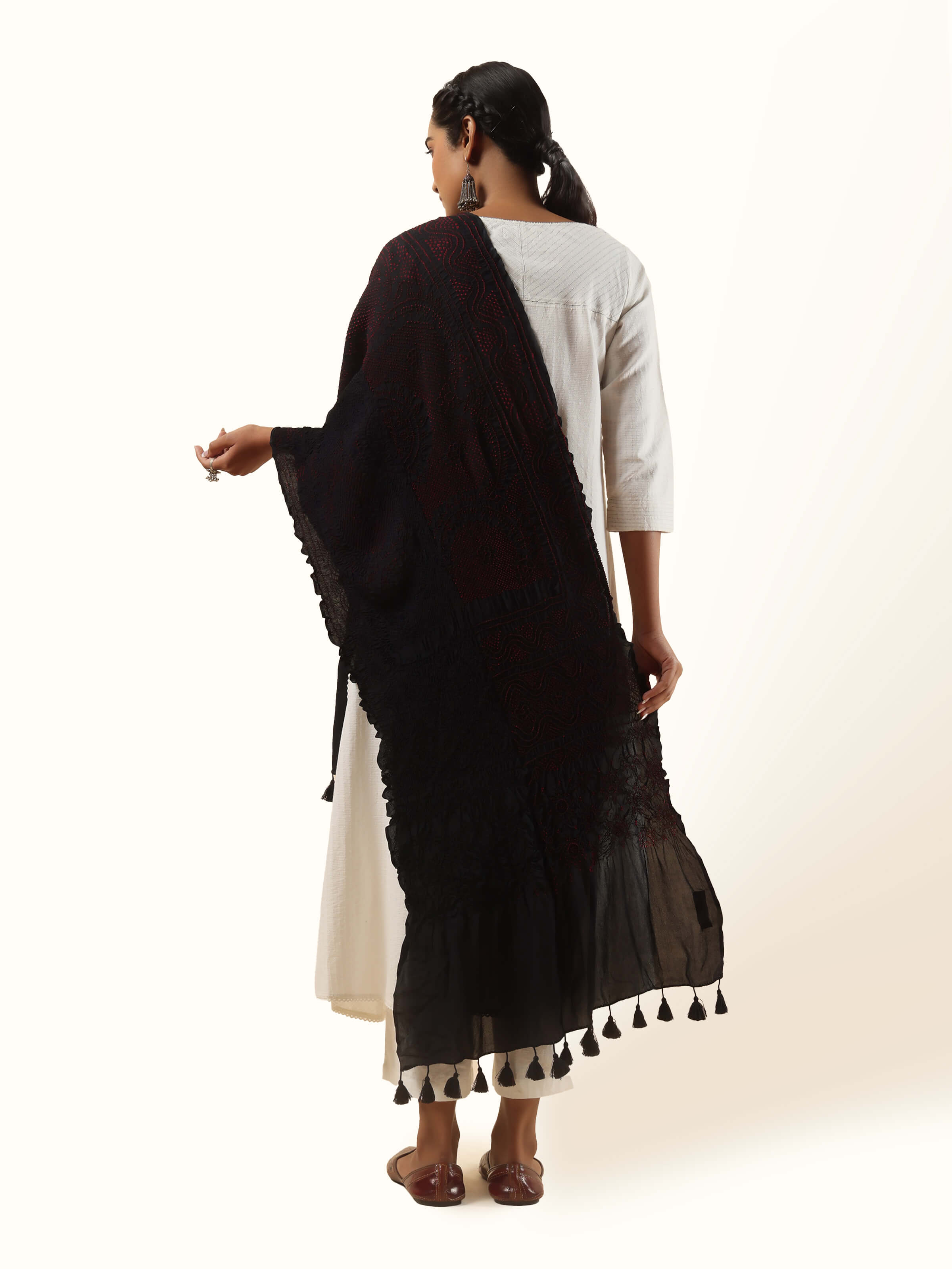 Back view of red silk Bandhani dupatta emphasizing its vibrant color and fine craftsmanship.
