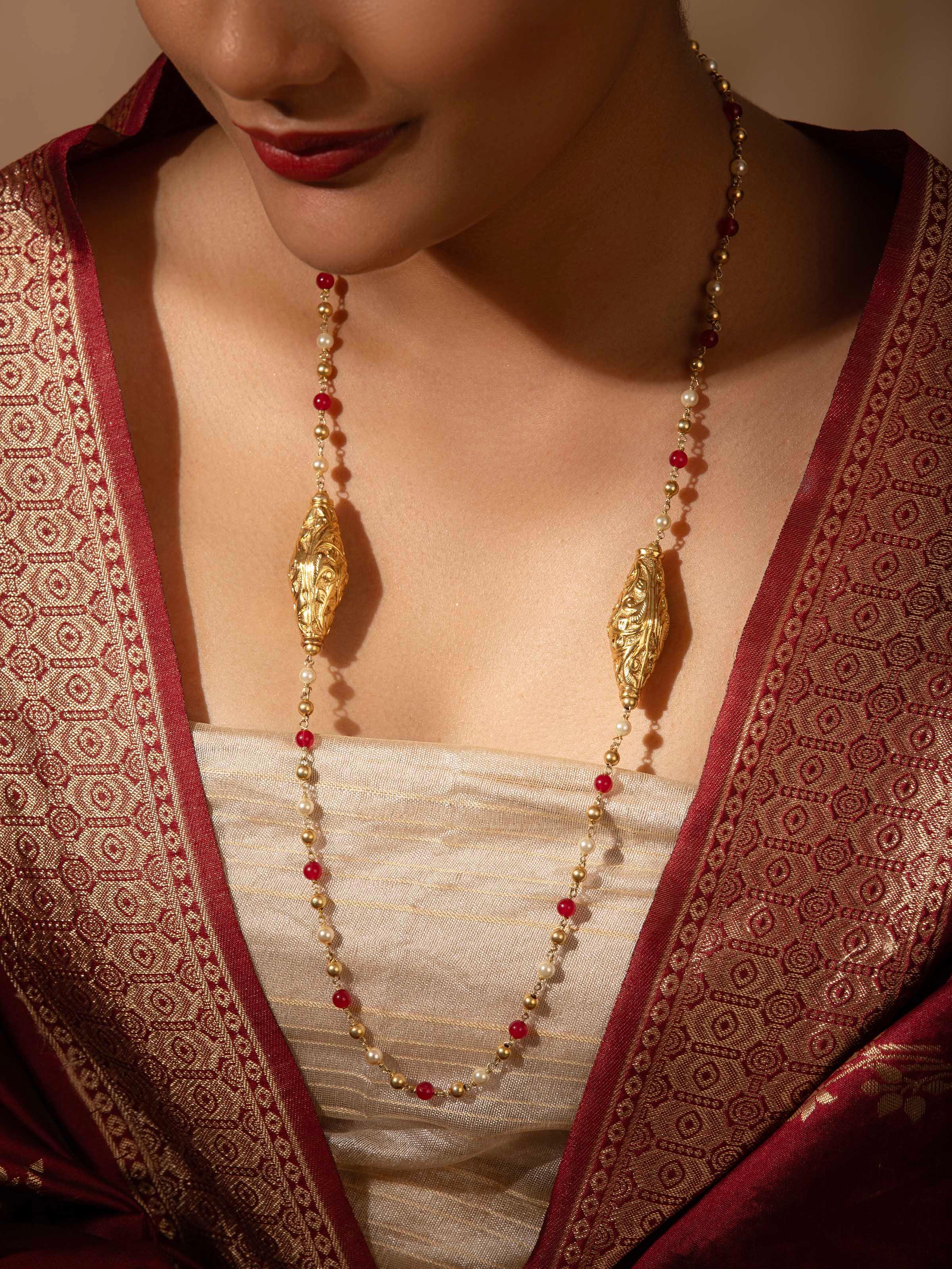 Side view of Chitai silver long necklace showcasing its elegant drape and detailed design.