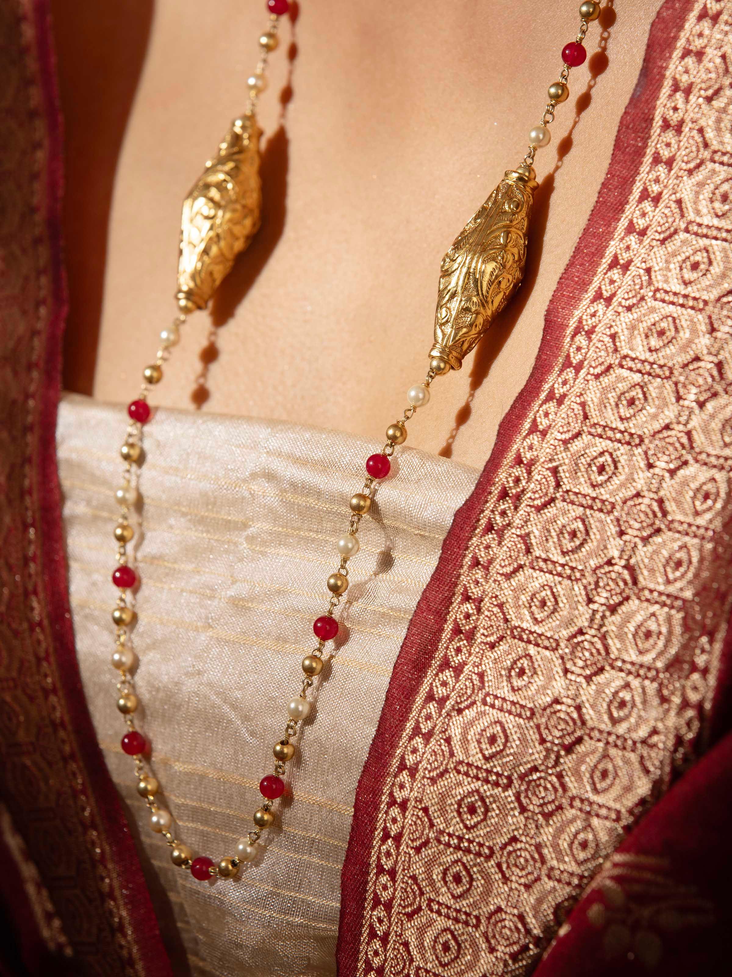 Angled view of Chitai silver long necklace highlighting the intricate silverwork and design.