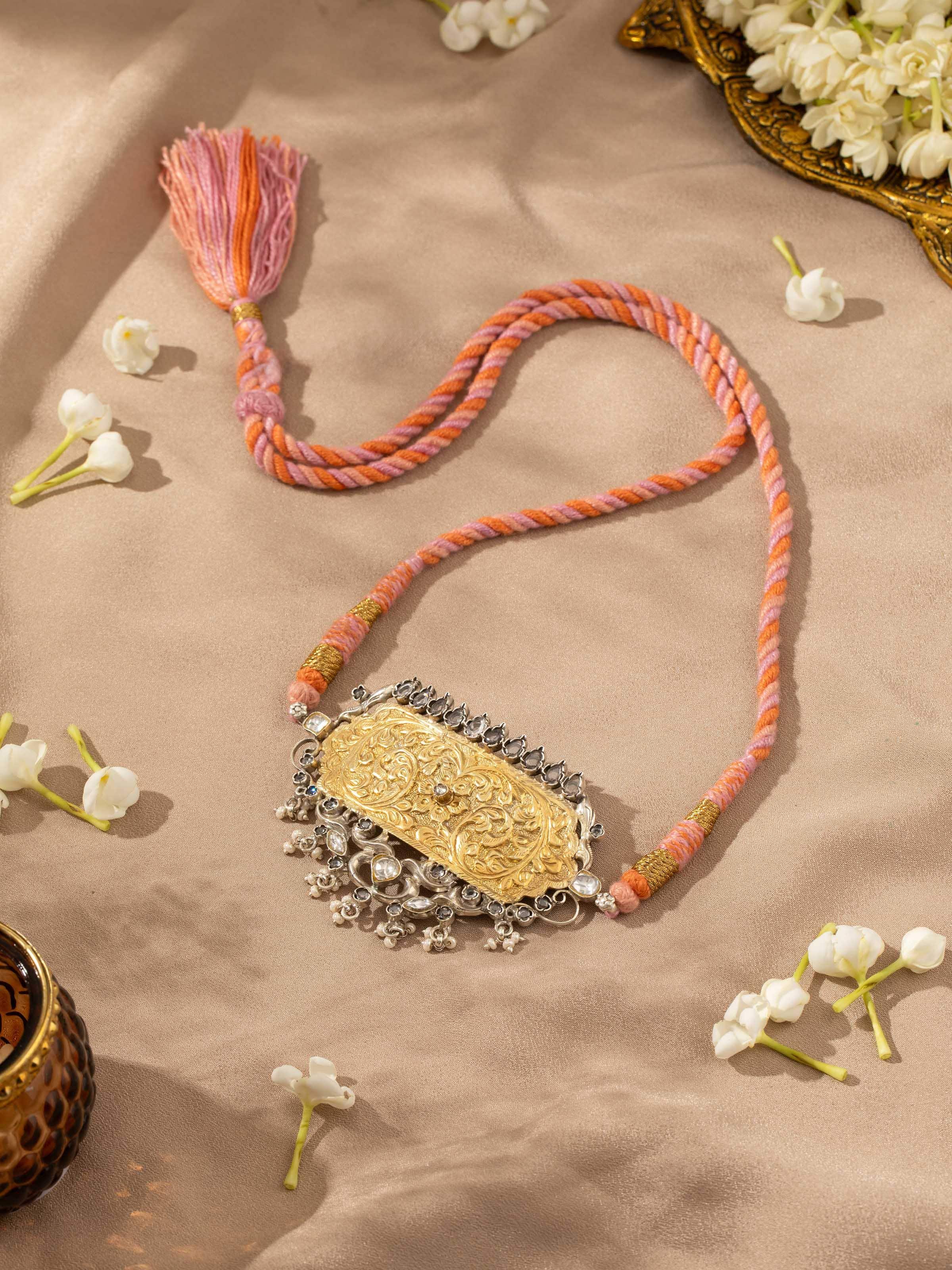 Overhead view of Chitai silver choker presenting its curved alignment and symmetrical artistry