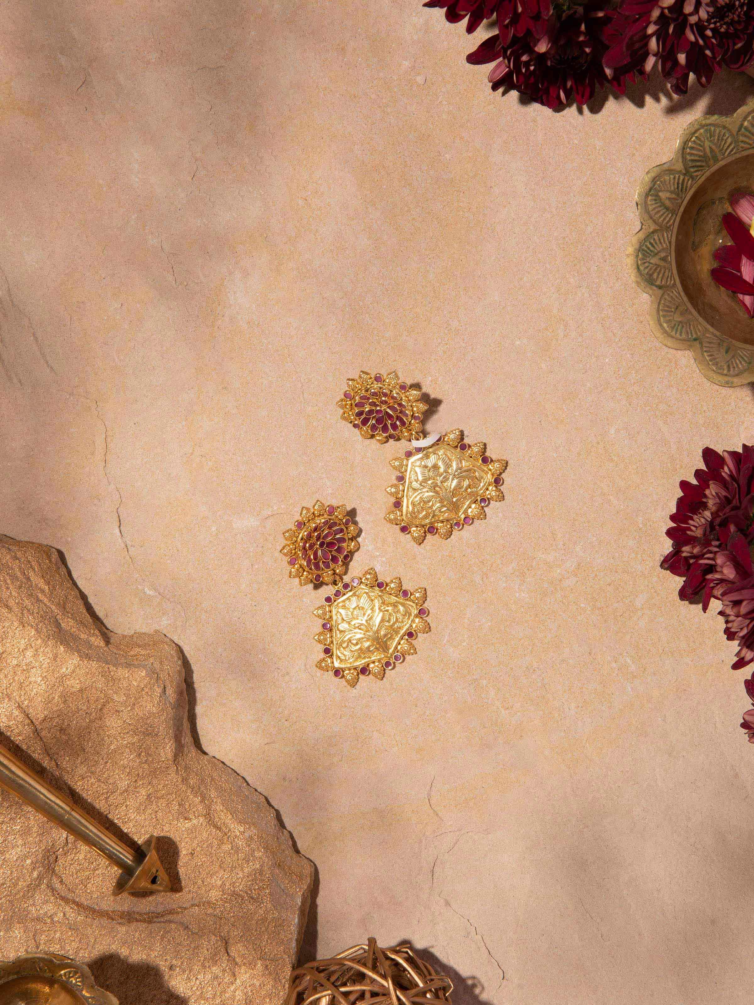 Angled view of silver chitai drop earrings showcasing elegant design and finish